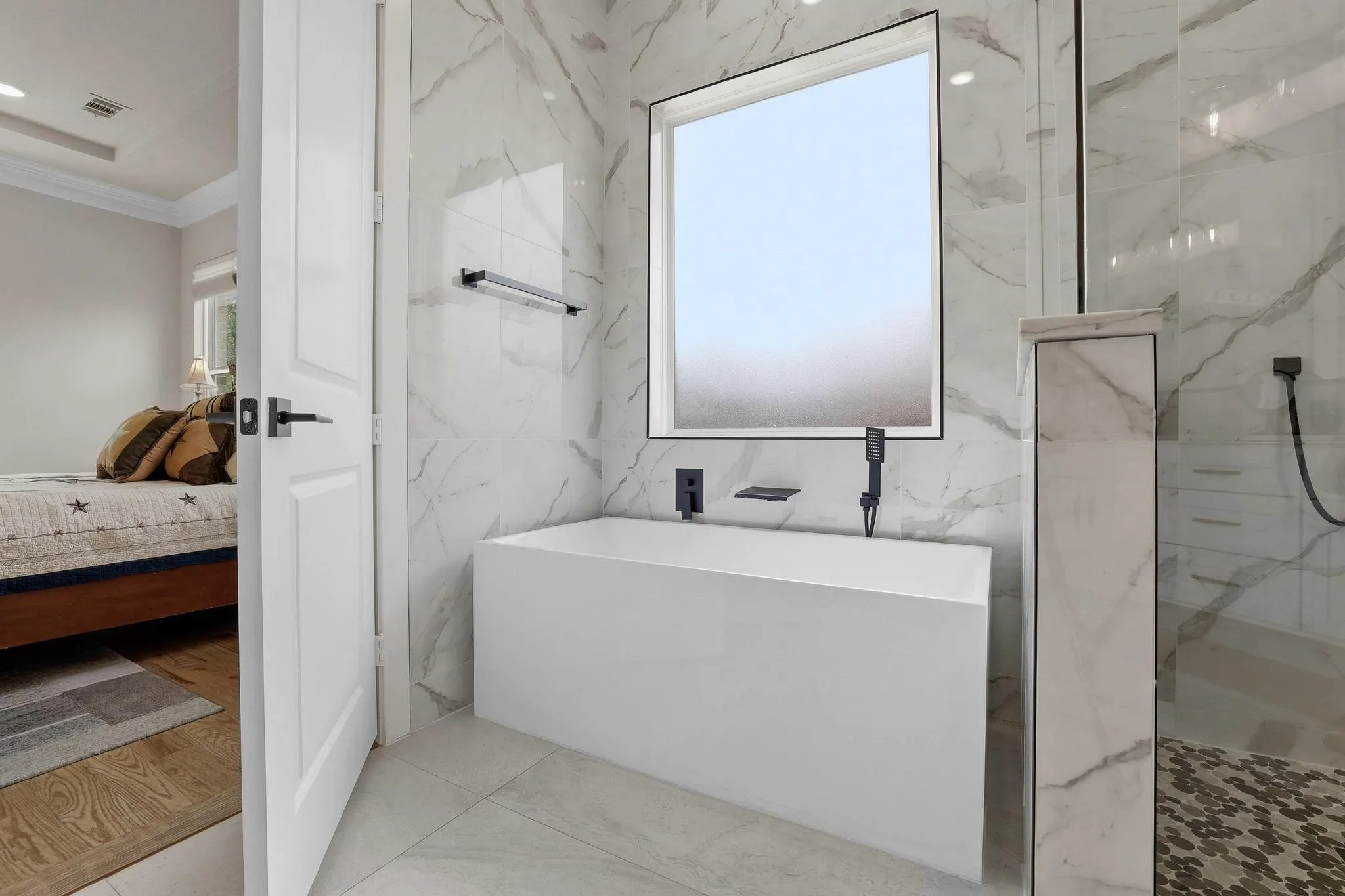 Full bath featuring ensuite bathroom, crown molding, a marble finish shower, and a freestanding tub