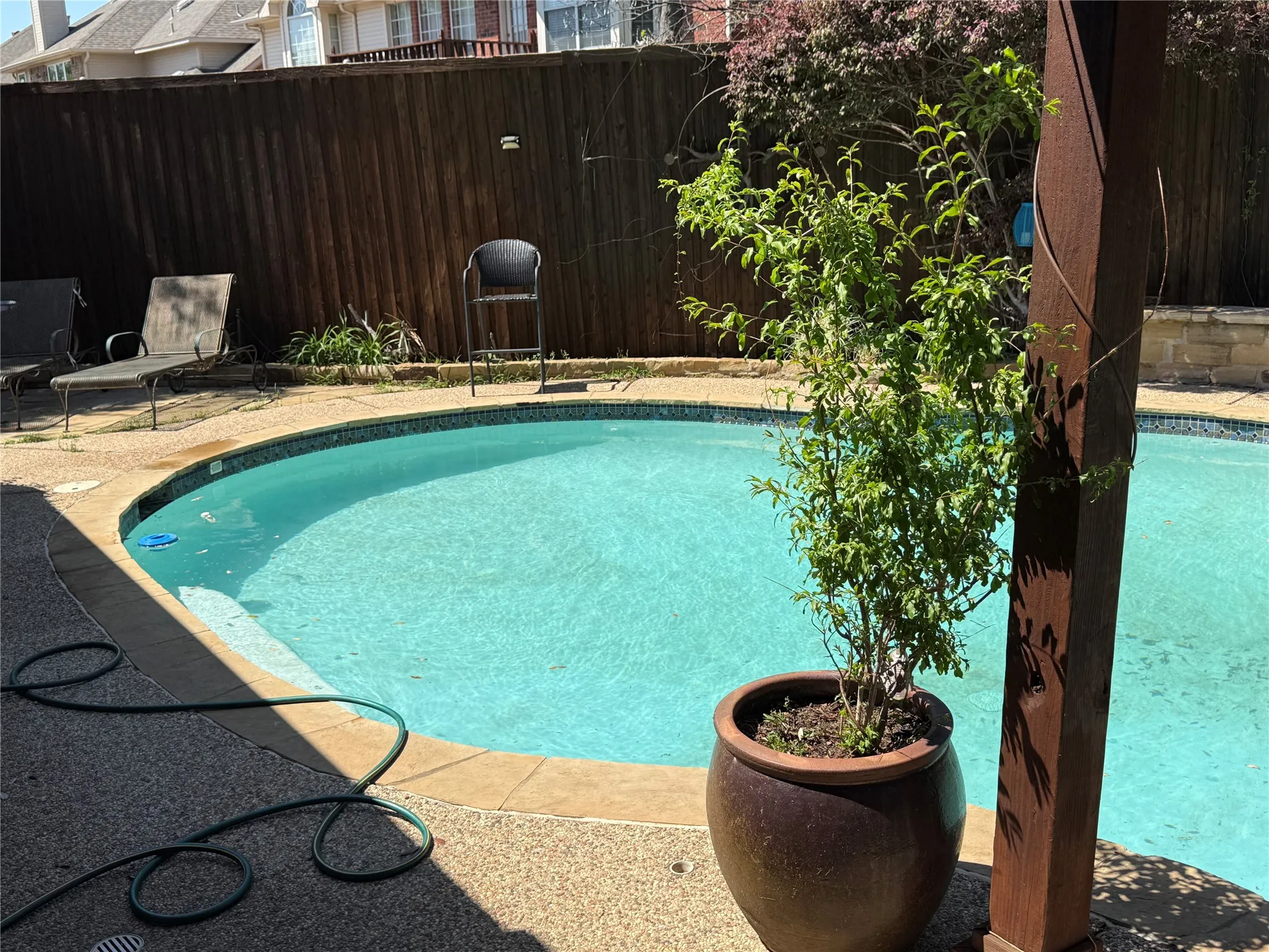 View of pool with a fenced backyard and patio surround