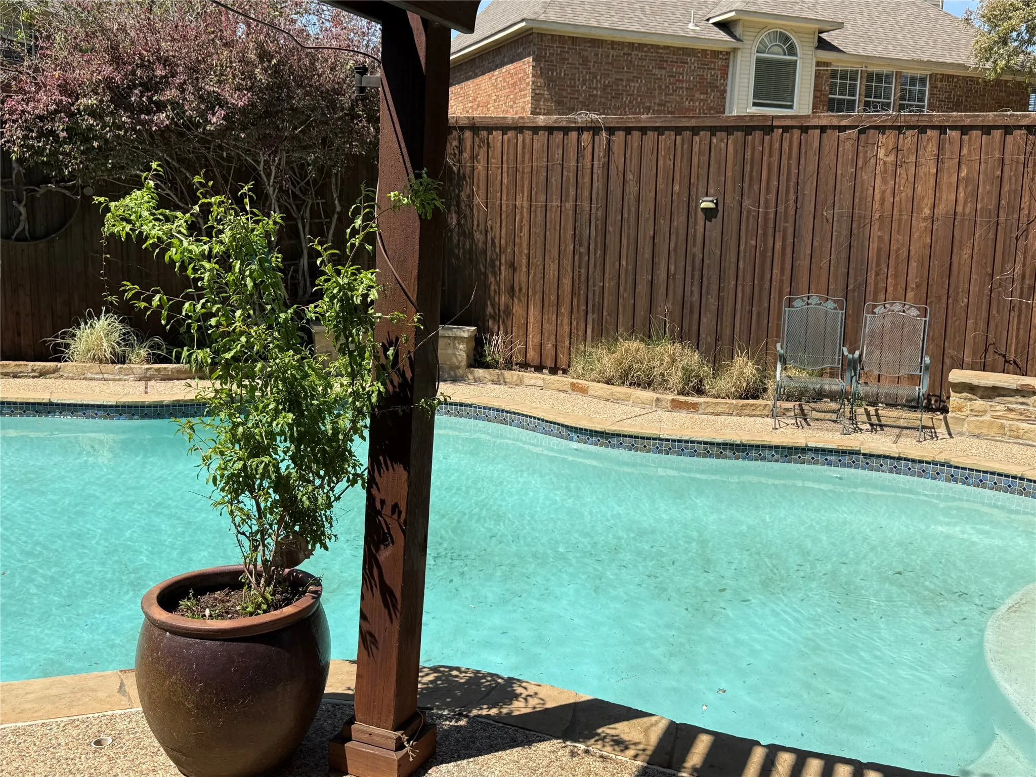 View of pool with a fenced backyard and patio surround
