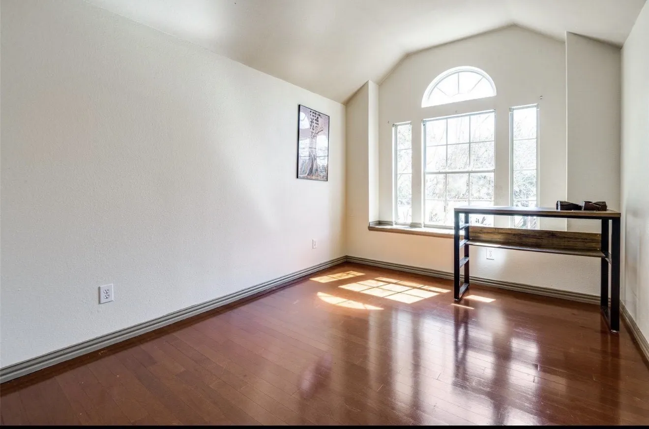 Unfurnished room featuring wood-type flooring and baseboards
