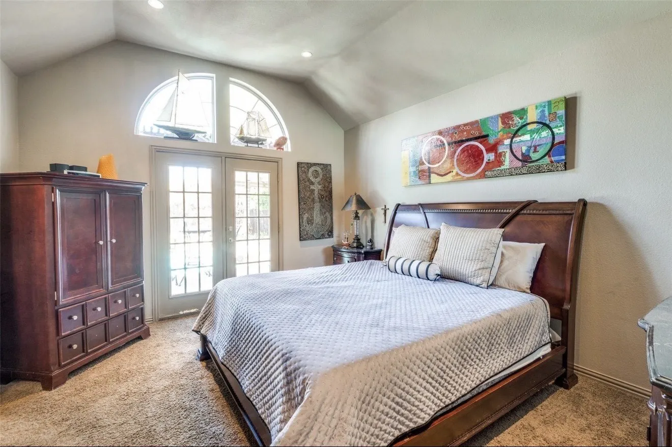 Bedroom featuring light colored carpet, french doors, and access to outside