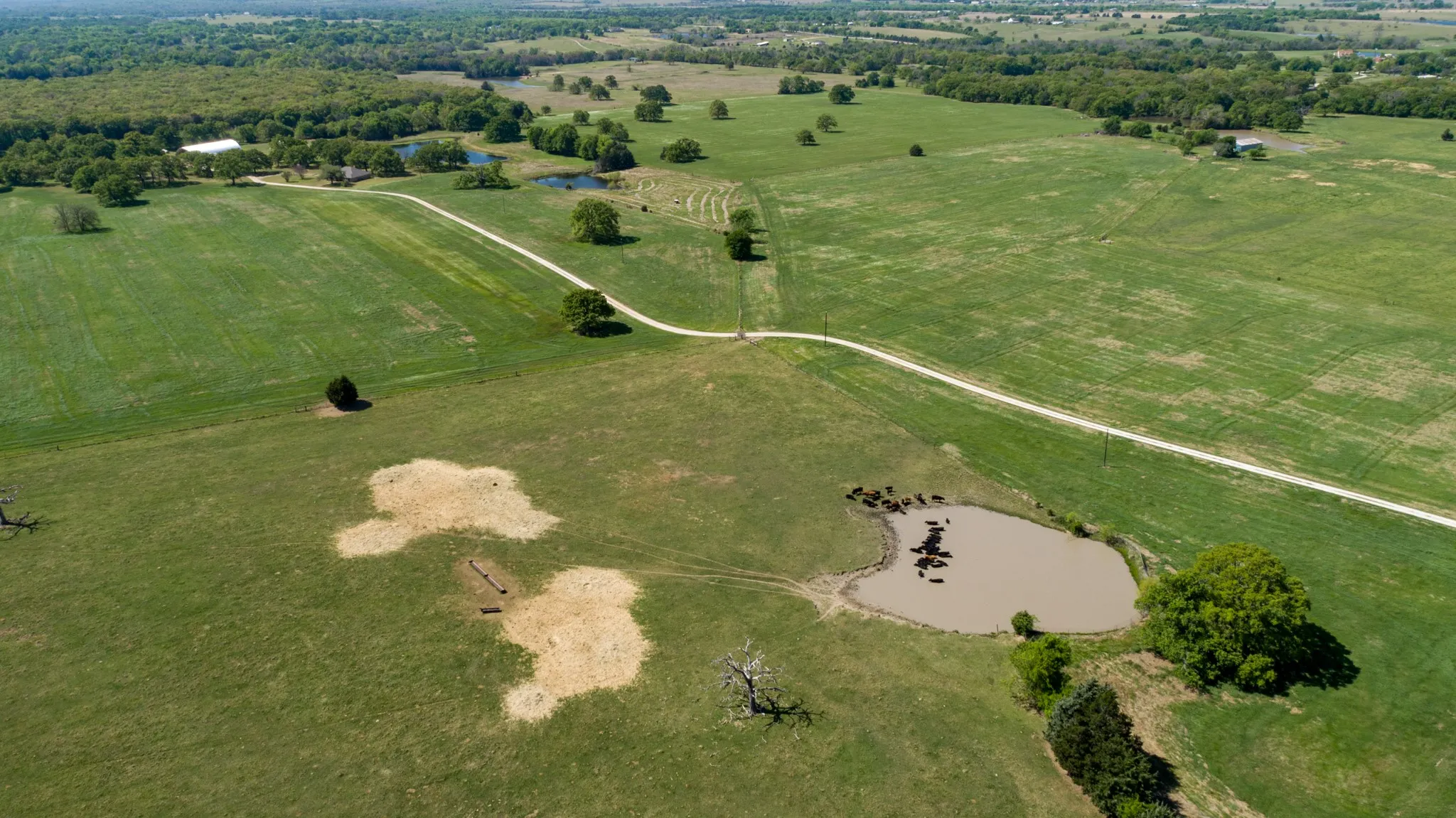Aerial overview of property's location with a nearby body of water and rural landscape