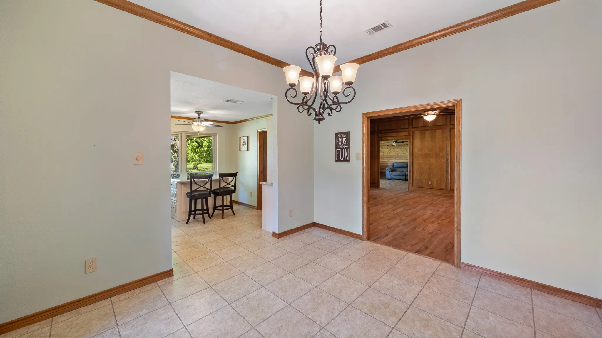 Formal Dining room, crown molding, suspended lighting, and light tile patterned flooring