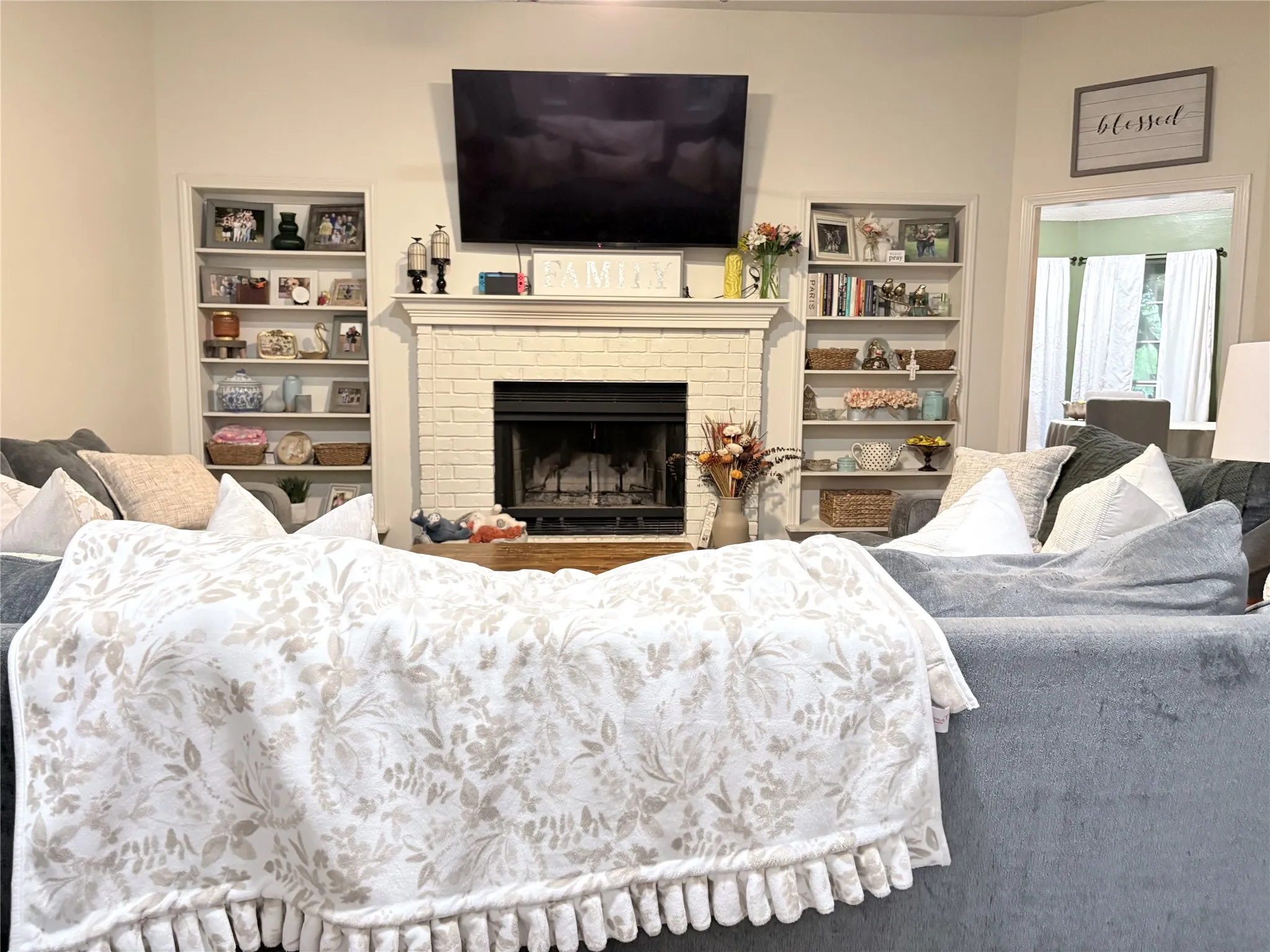 Living area featuring a fireplace and built in shelves