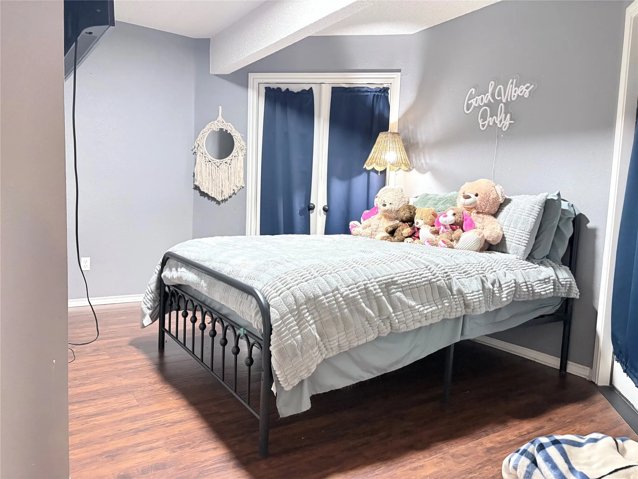 Bedroom with wood finished floors and baseboards