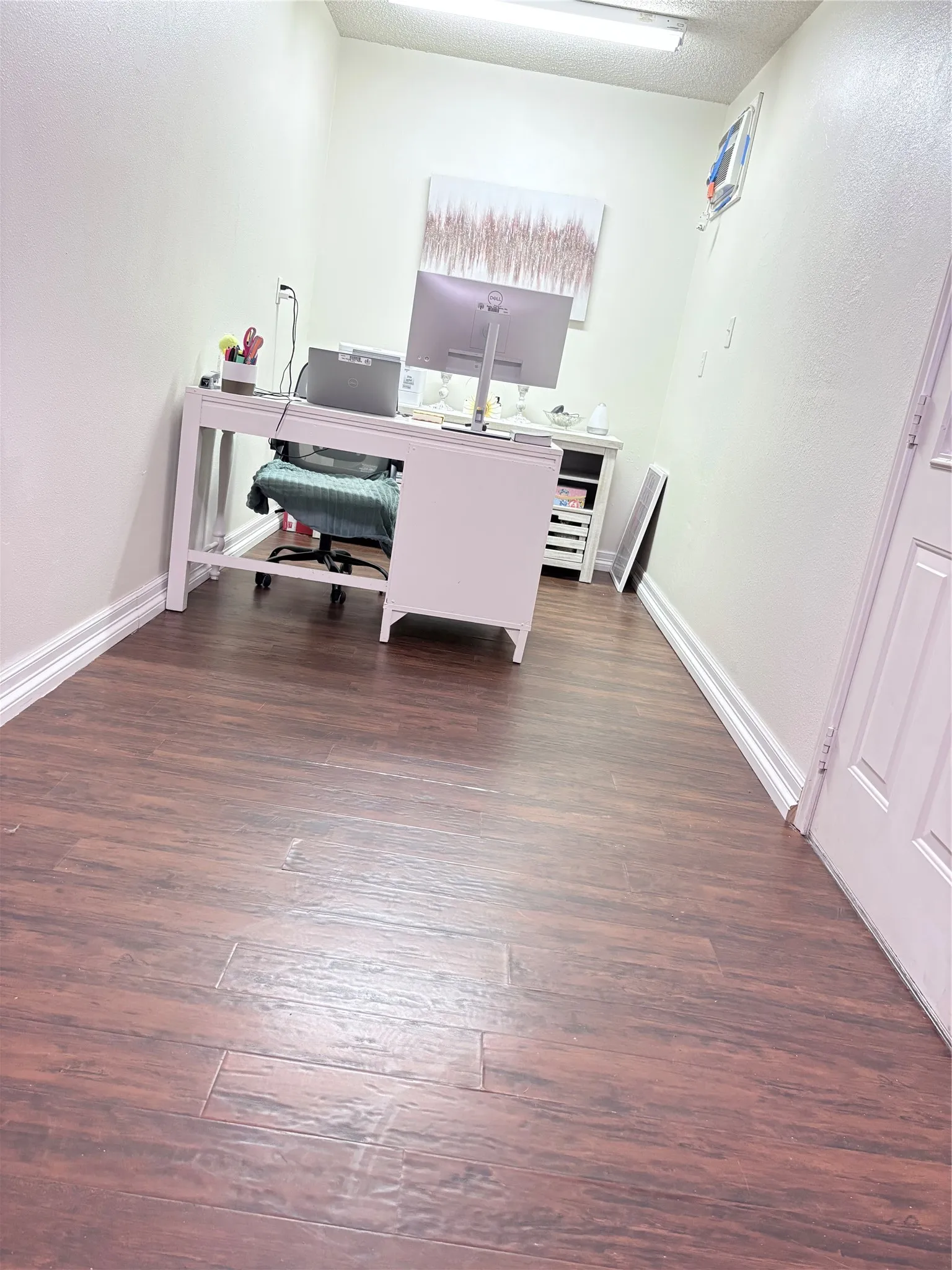 Office area with dark wood finished floors and a textured ceiling