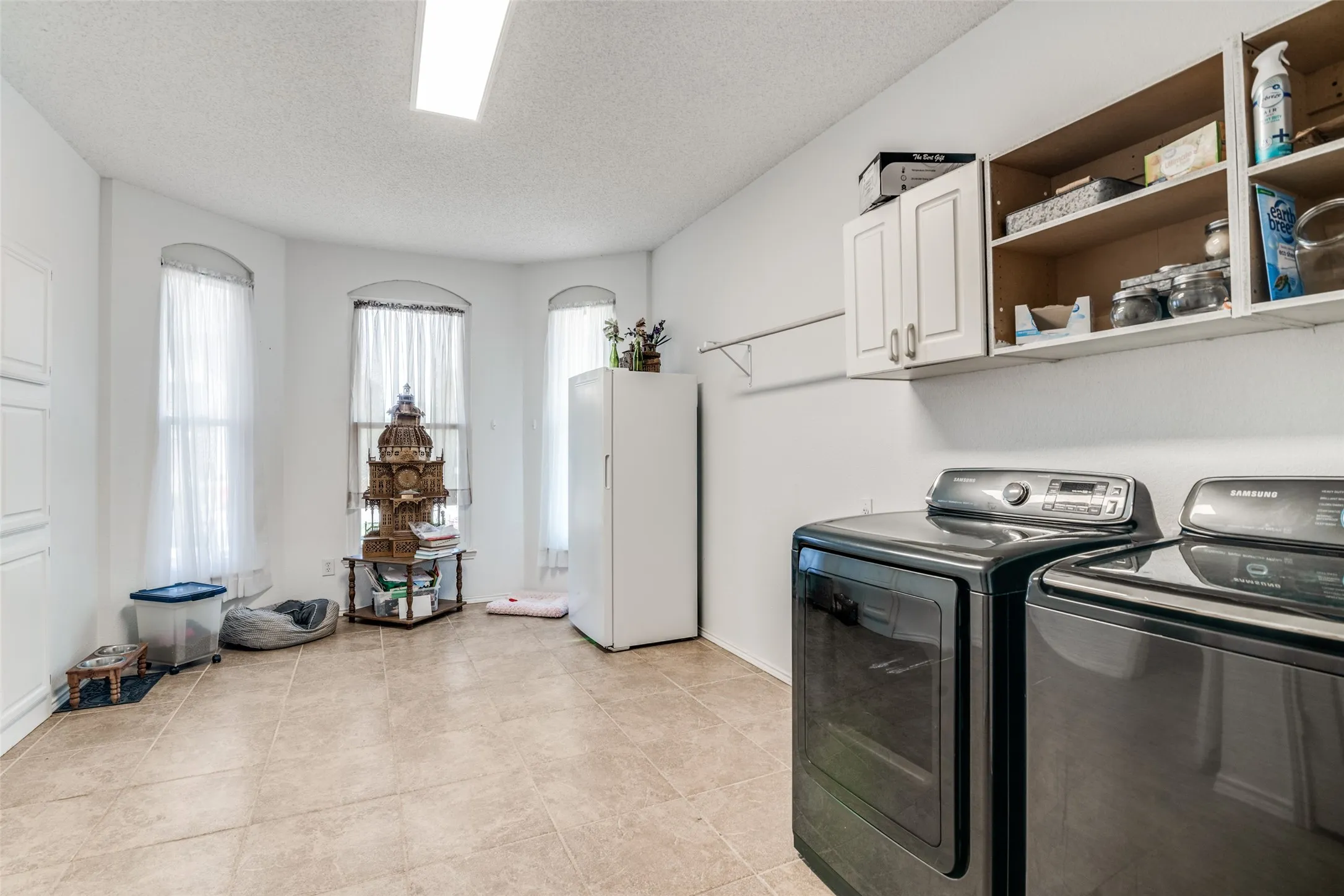Oversized laundry room could also be used as home organization office or excercise room