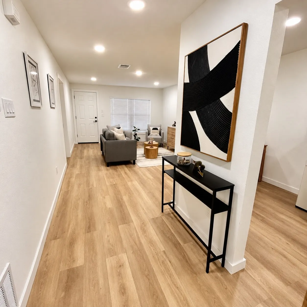 Recessed lighting, wood-finish flooring, white paneled door, and window with horizontal blinds