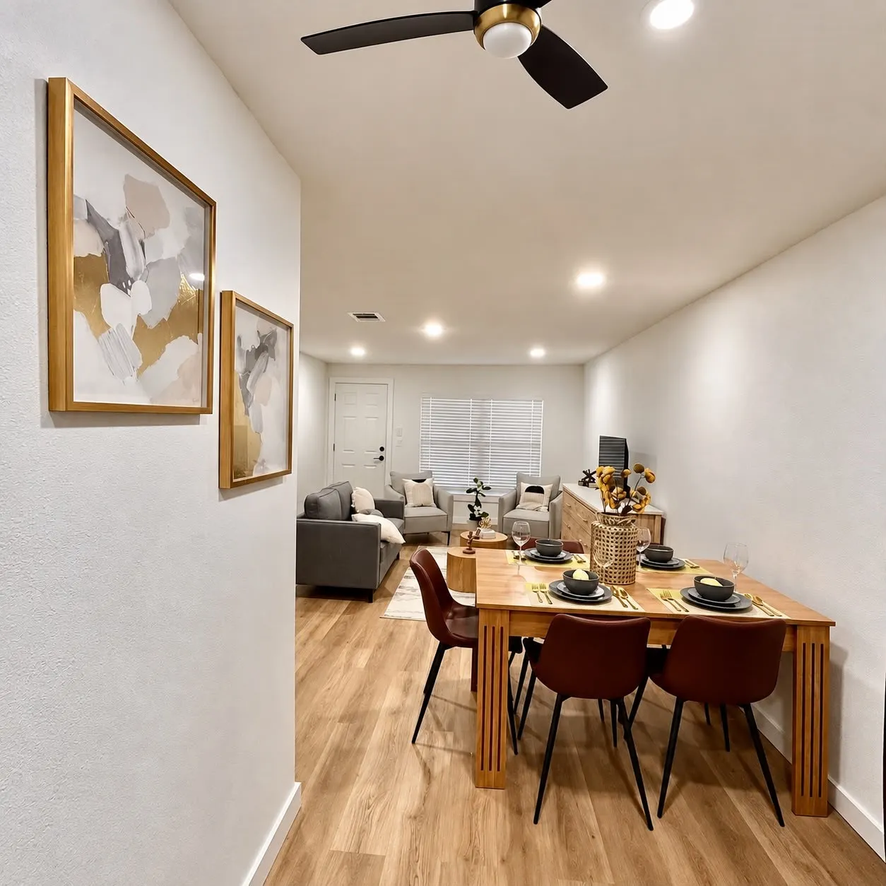 Recessed lighting illuminates wood-finish flooring throughout