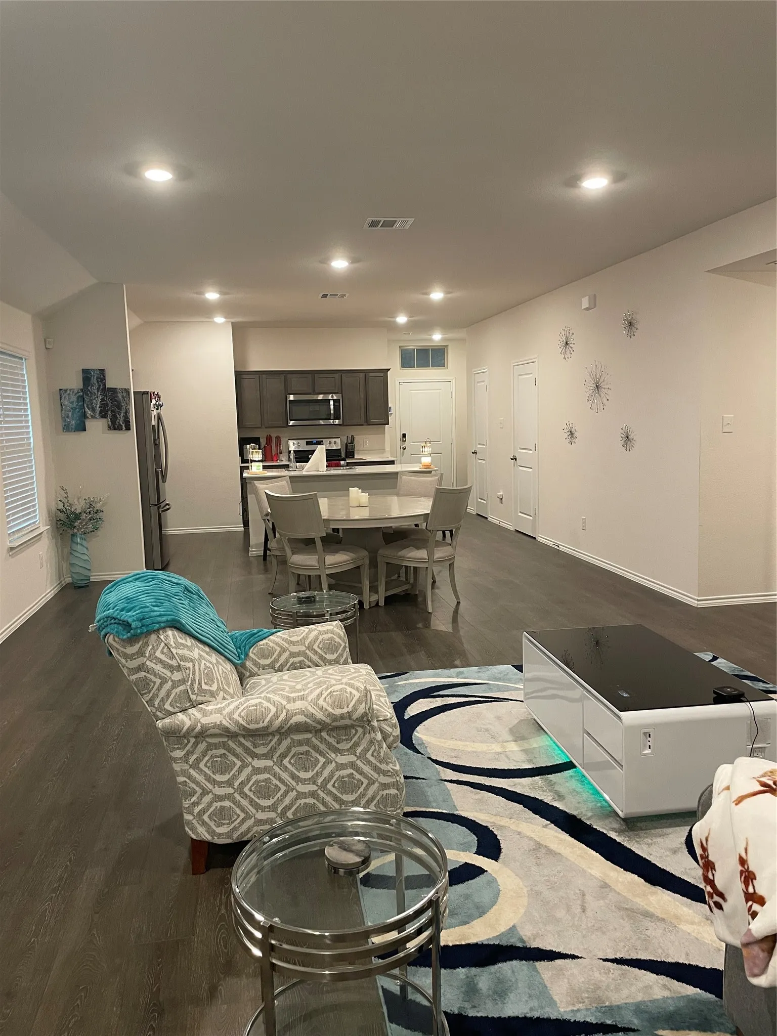 Living room featuring dark wood-style flooring and recessed lighting