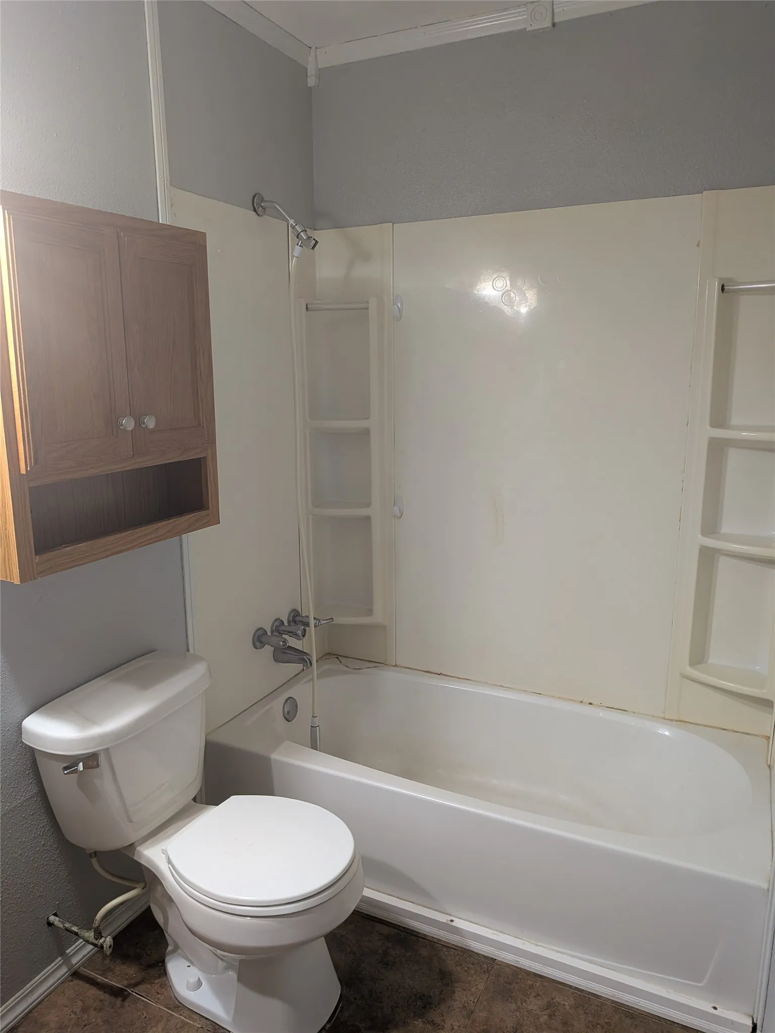 Full bathroom with crown molding and shower / tub combination