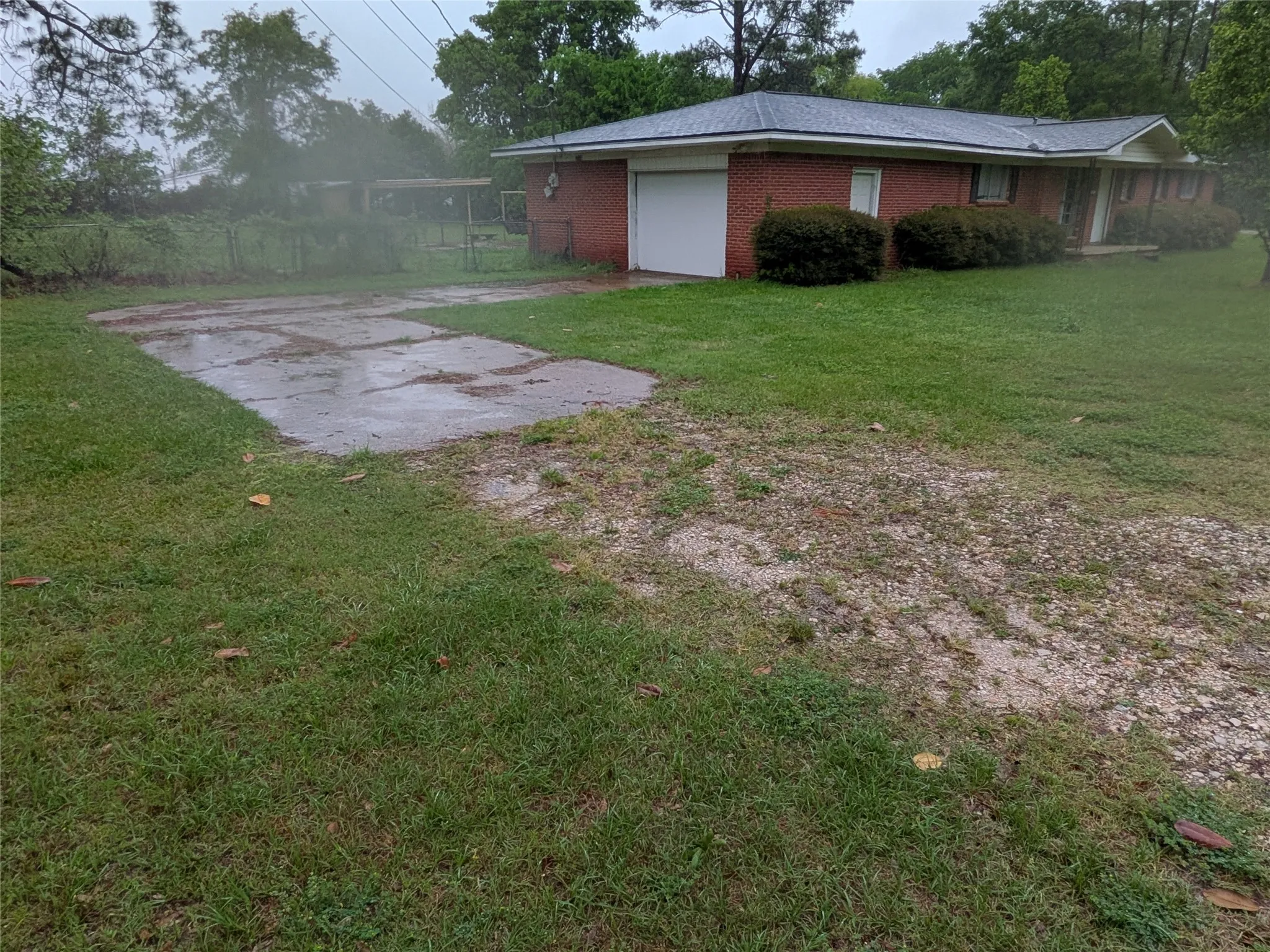 Single story home with brick siding, a garage, and a front lawn