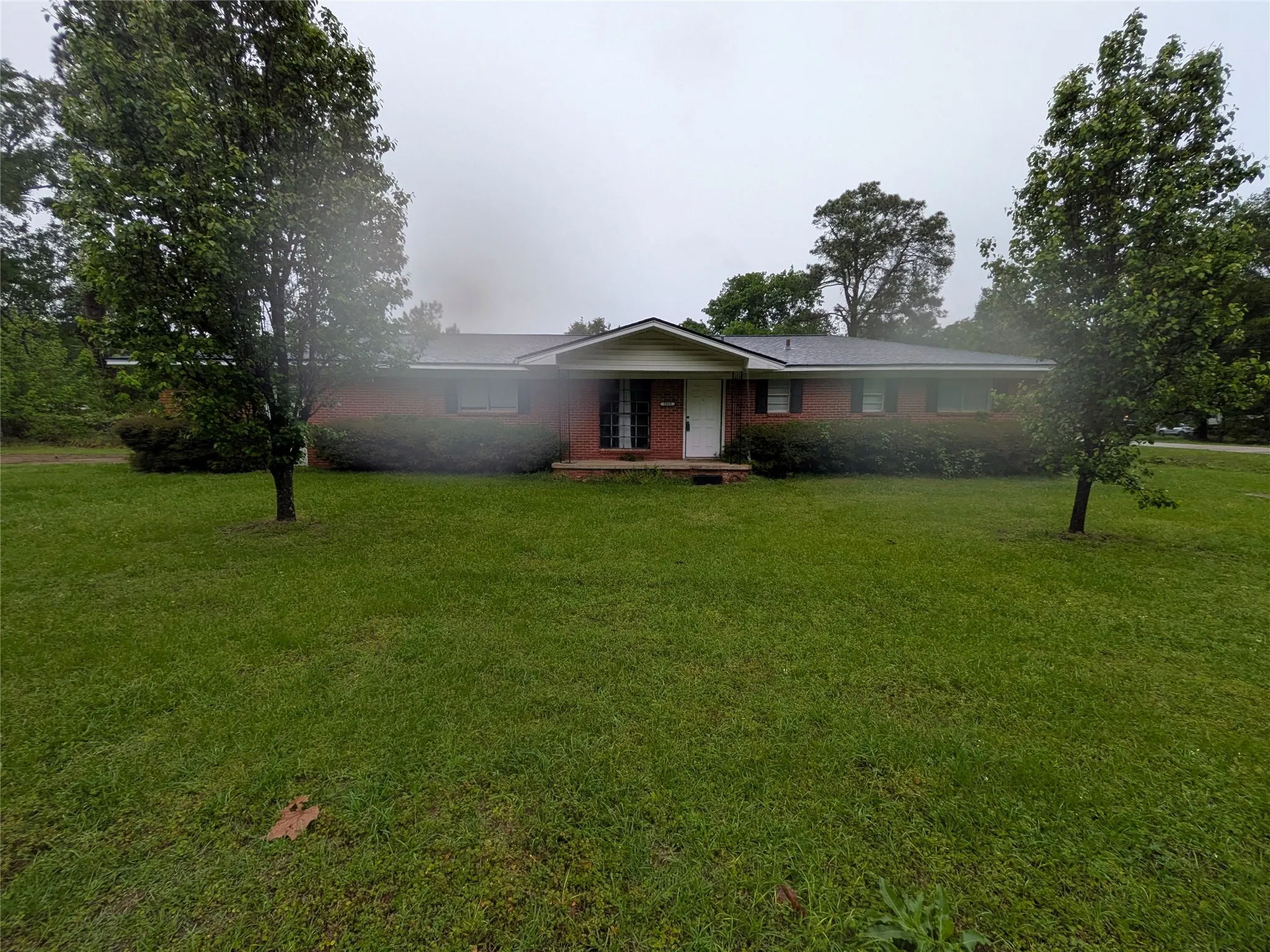 Single story home with a front yard and a porch