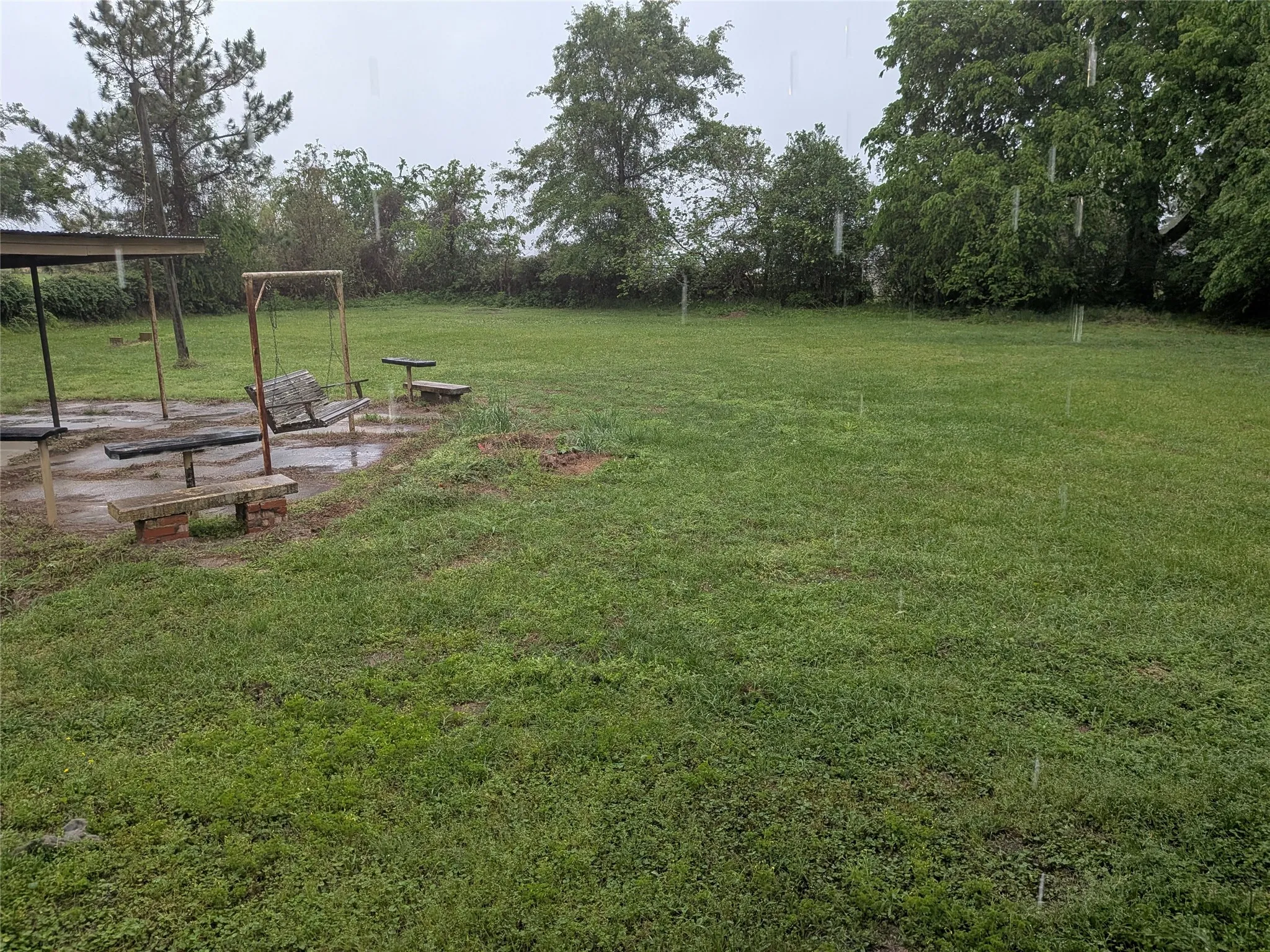 View of grassy yard with a patio area
