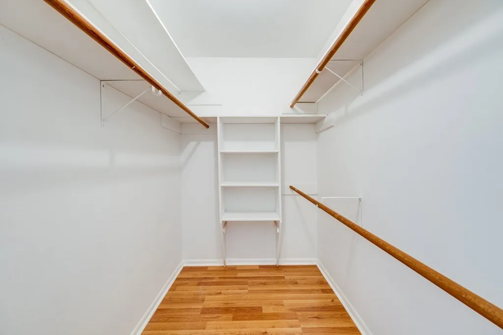Walk in closet featuring light wood-style flooring