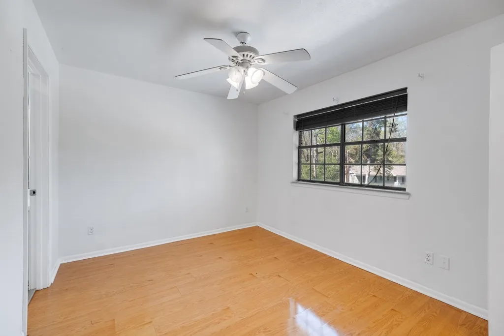 Unfurnished room with light wood finished floors and ceiling fan