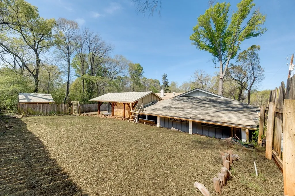 Rear view of house with roof with shingles and board and batten siding