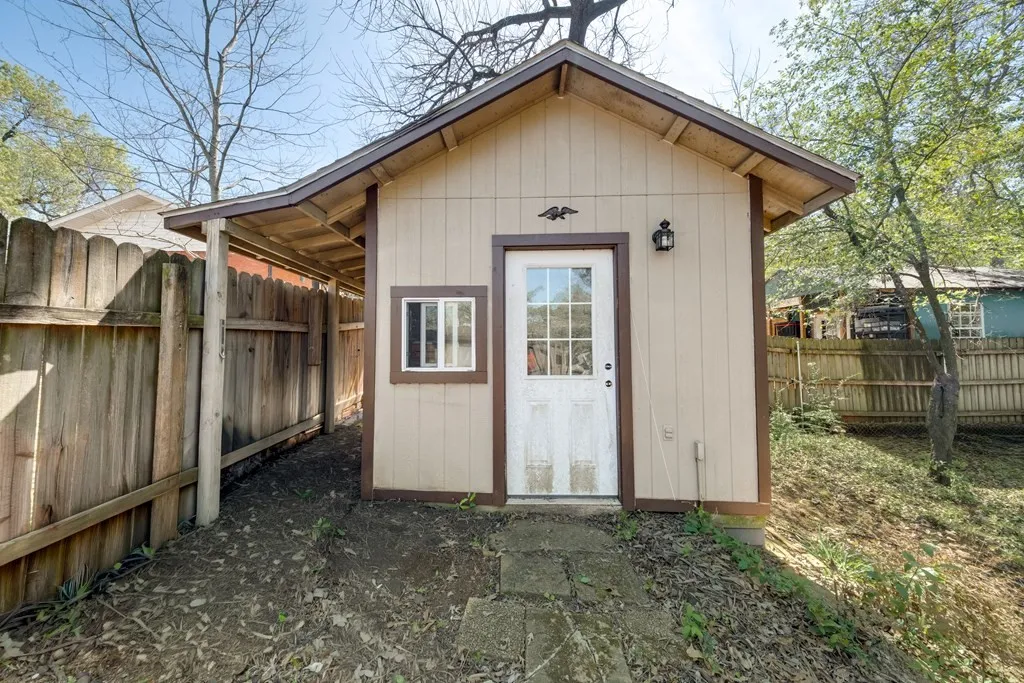 View of shed with a fenced backyard