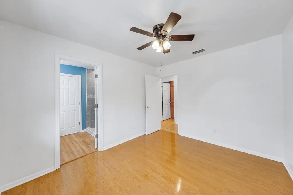 Unfurnished bedroom featuring light wood-style flooring and a ceiling fan