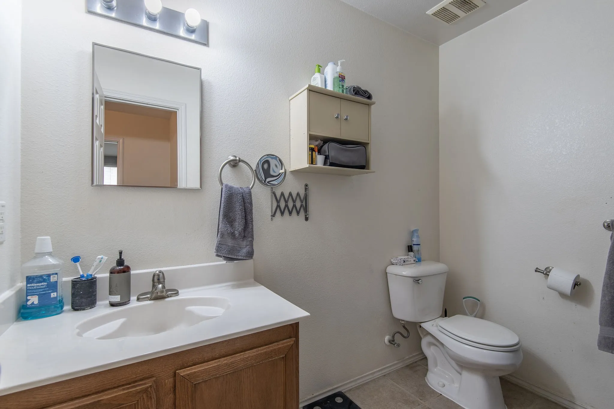 Half bath featuring vanity and light tile patterned floors