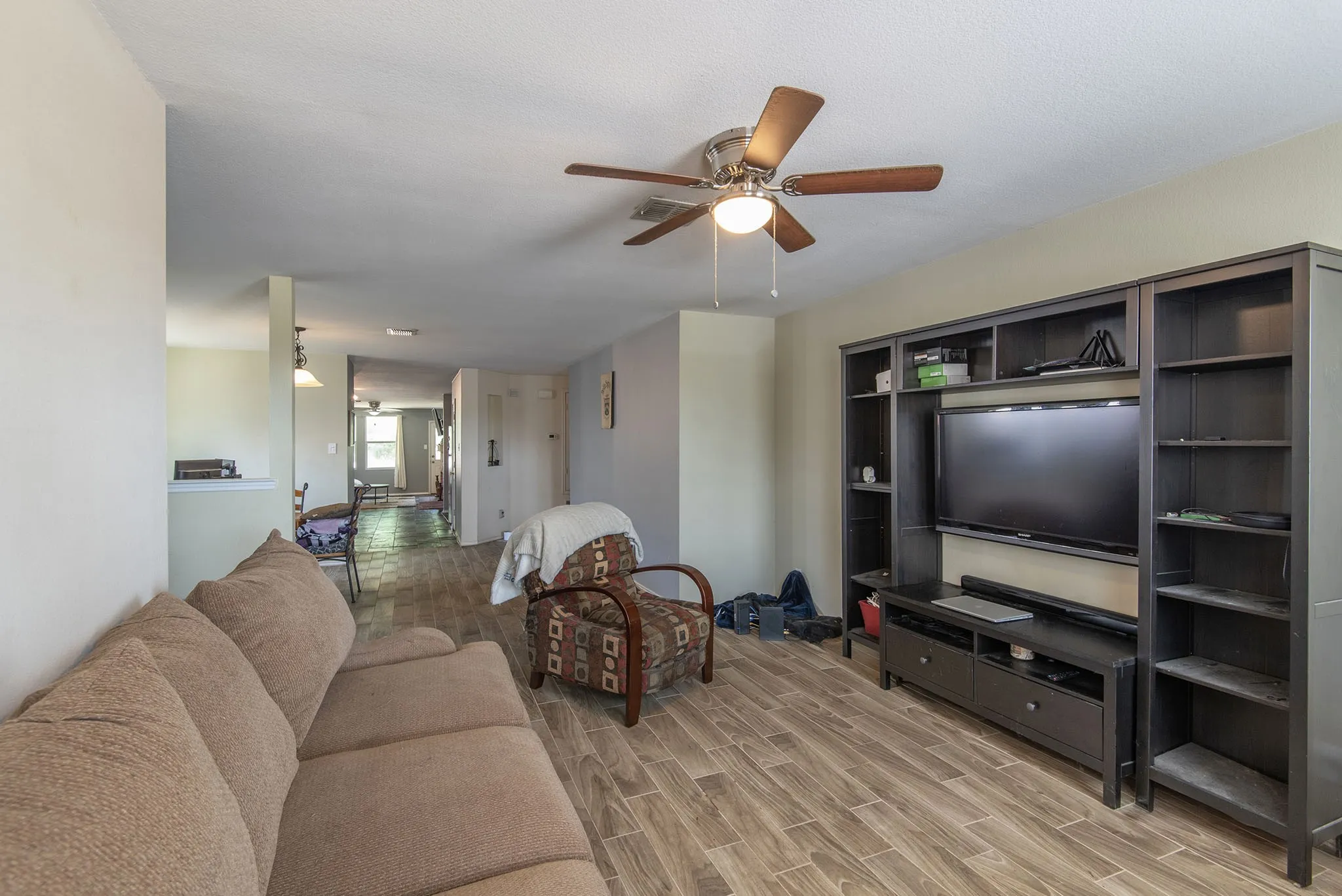 Living room with wood finish floors and ceiling fan