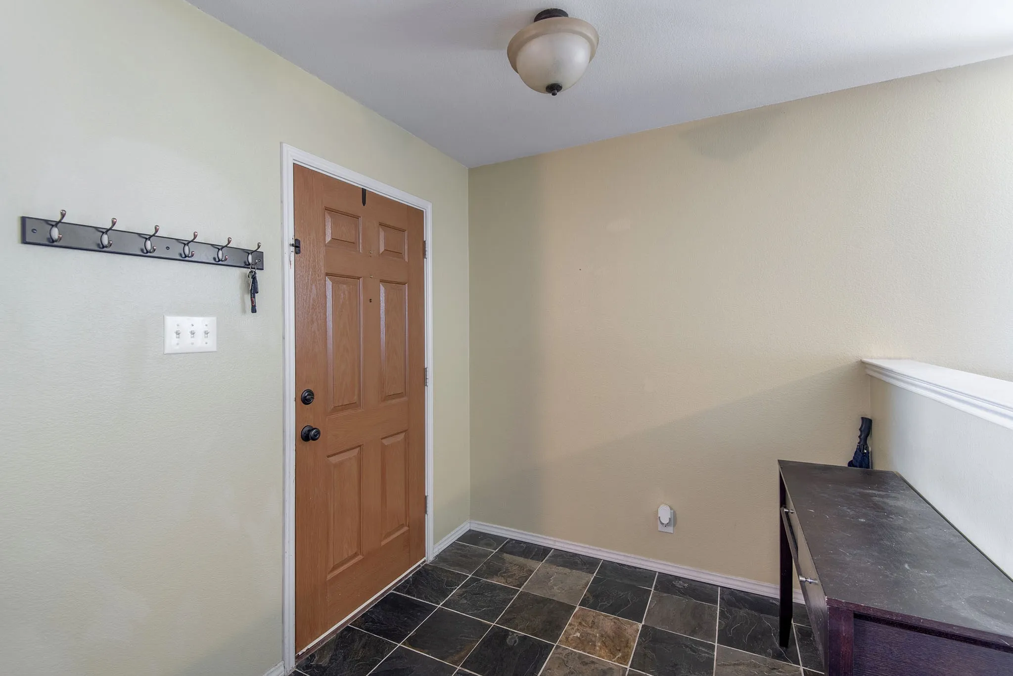 Entrance foyer with stone finish flooring and baseboards