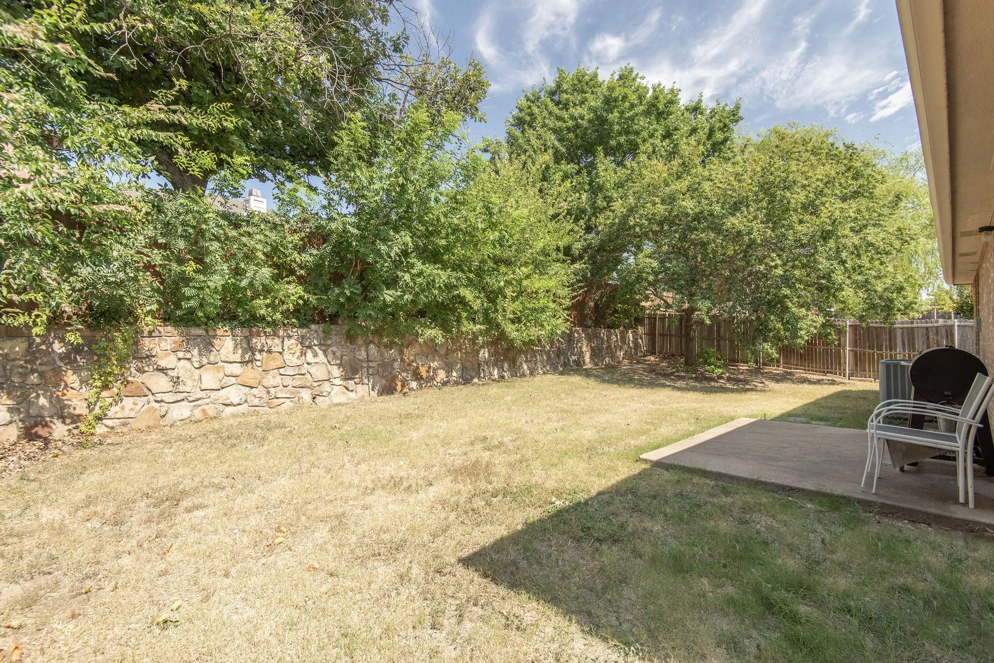 Fenced backyard featuring a patio area