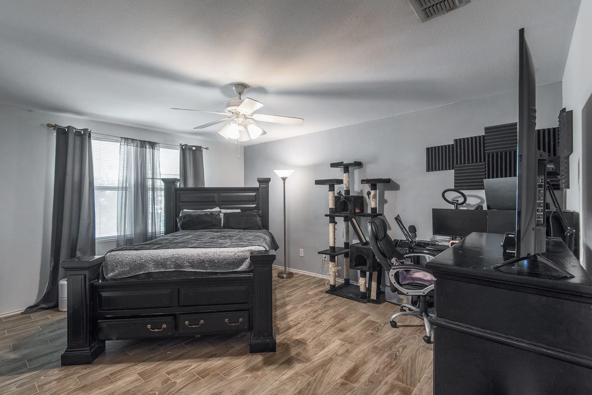 Bedroom featuring wood finish floors and a ceiling fan