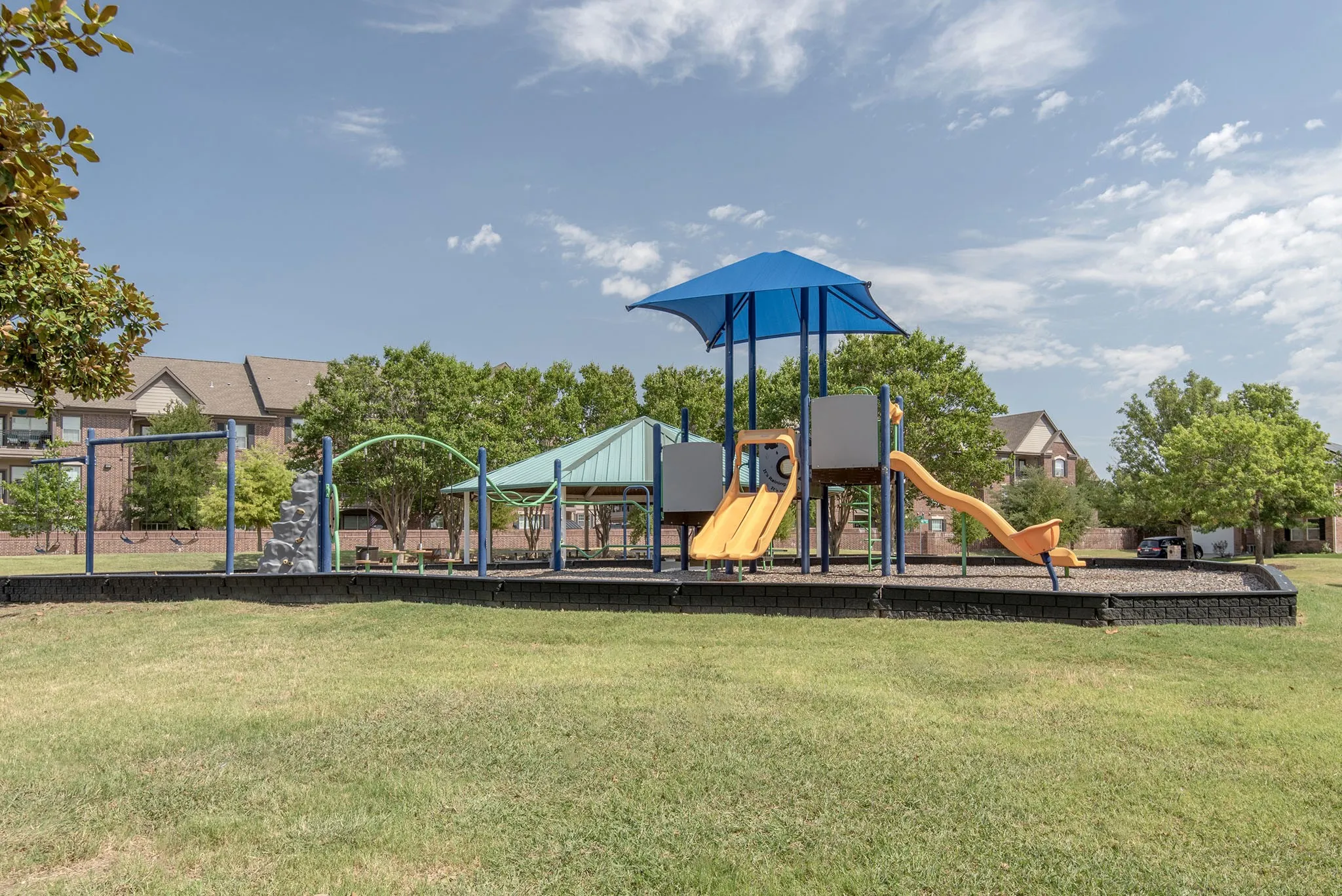 Community jungle gym featuring a lawn