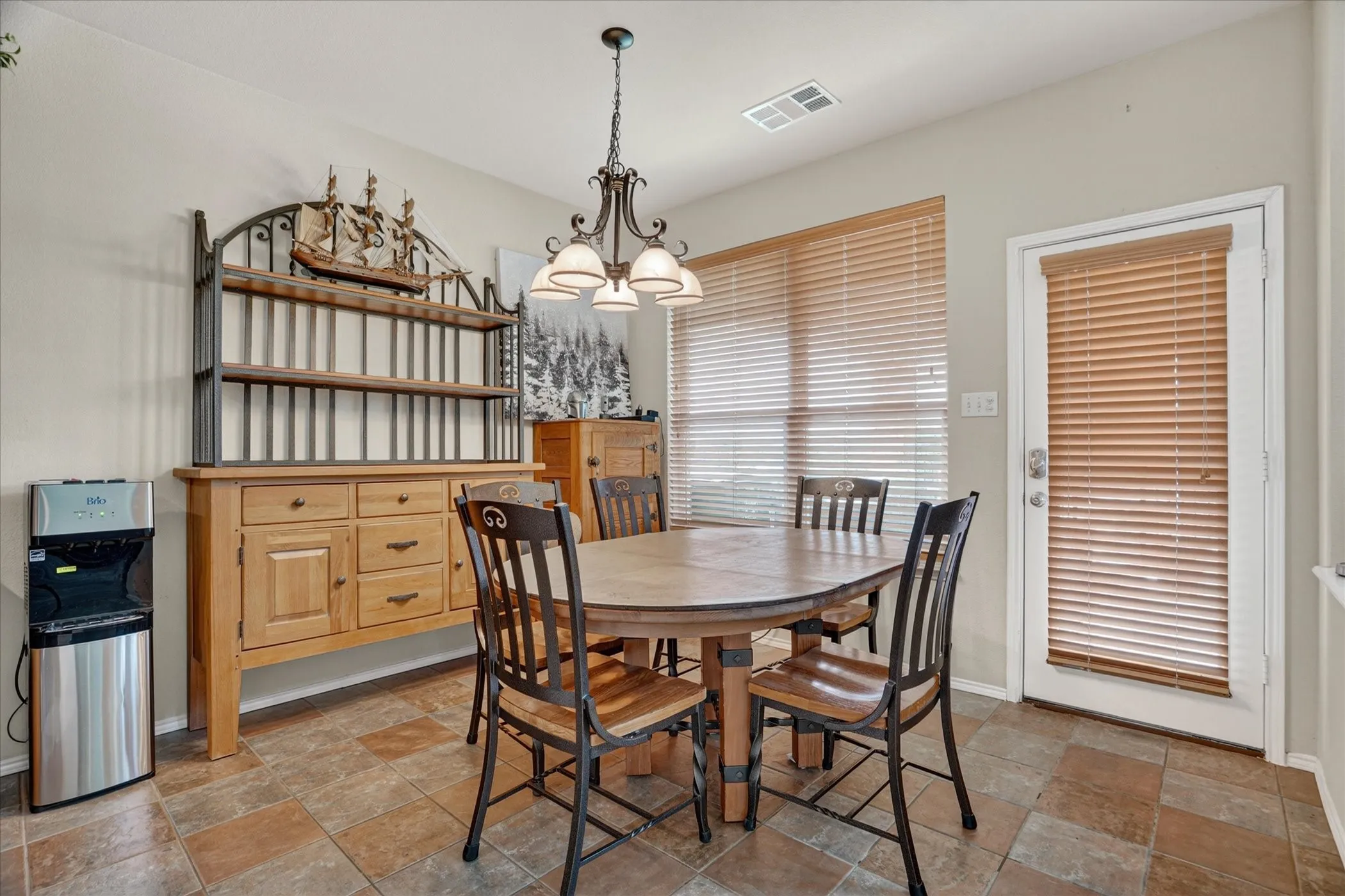Dining area featuring multi-toned tile flooring and neutral wall paint