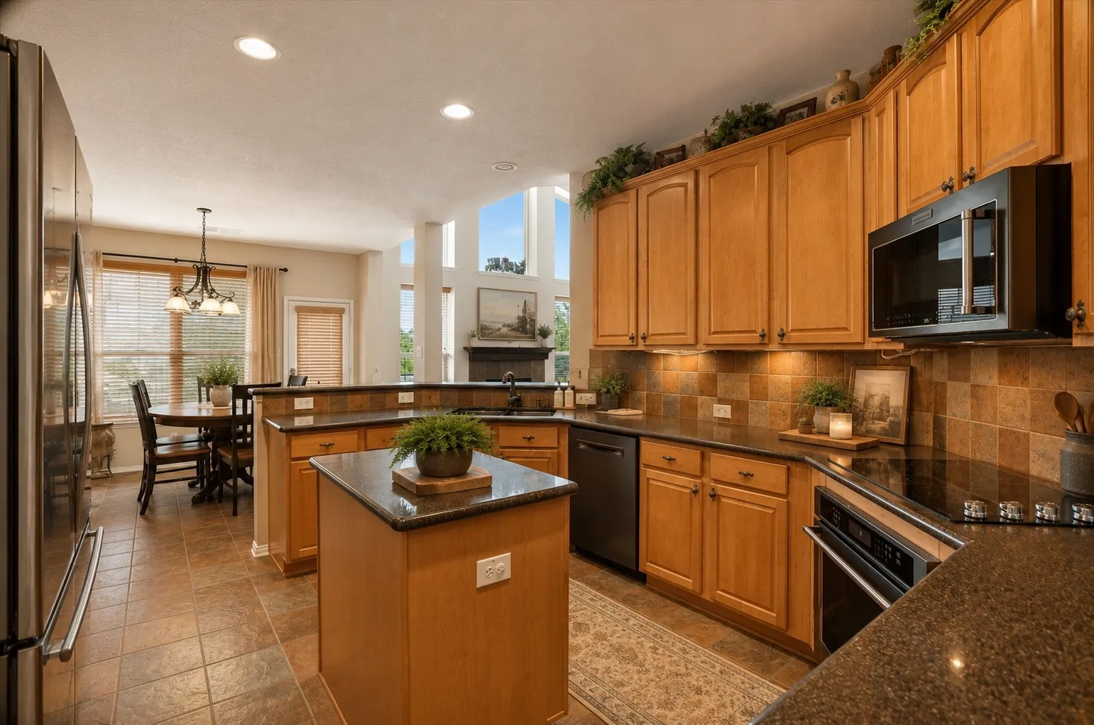 Virtually staged Kitchen featuring wood cabinetry, dark countertops, tiled flooring, an integrated microwave, and an electric range