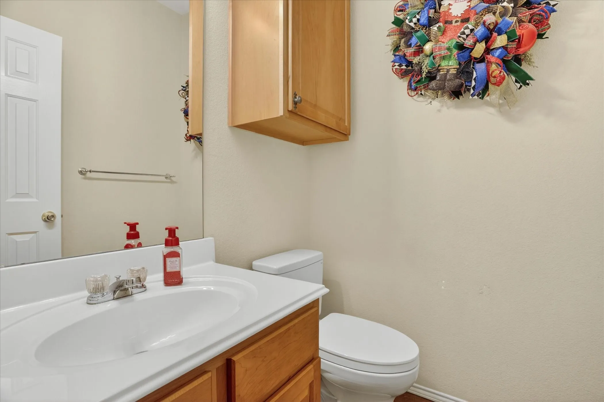 Vanity with a white integrated sink and laminate countertop