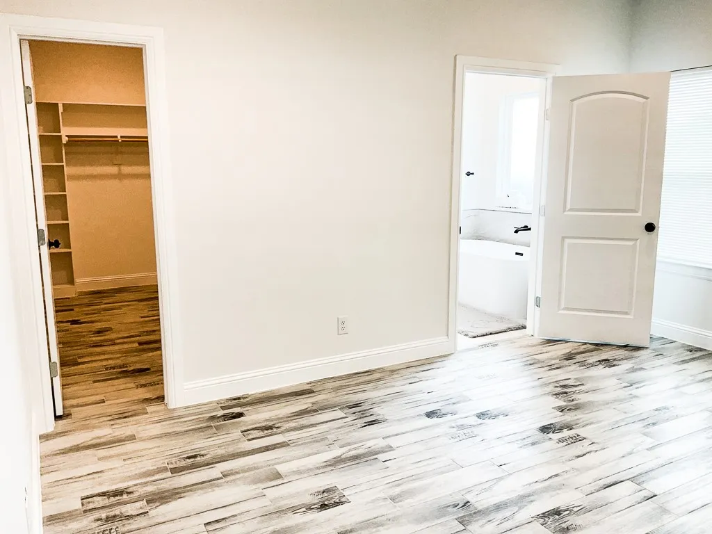 Large primary bedroom with accent wall