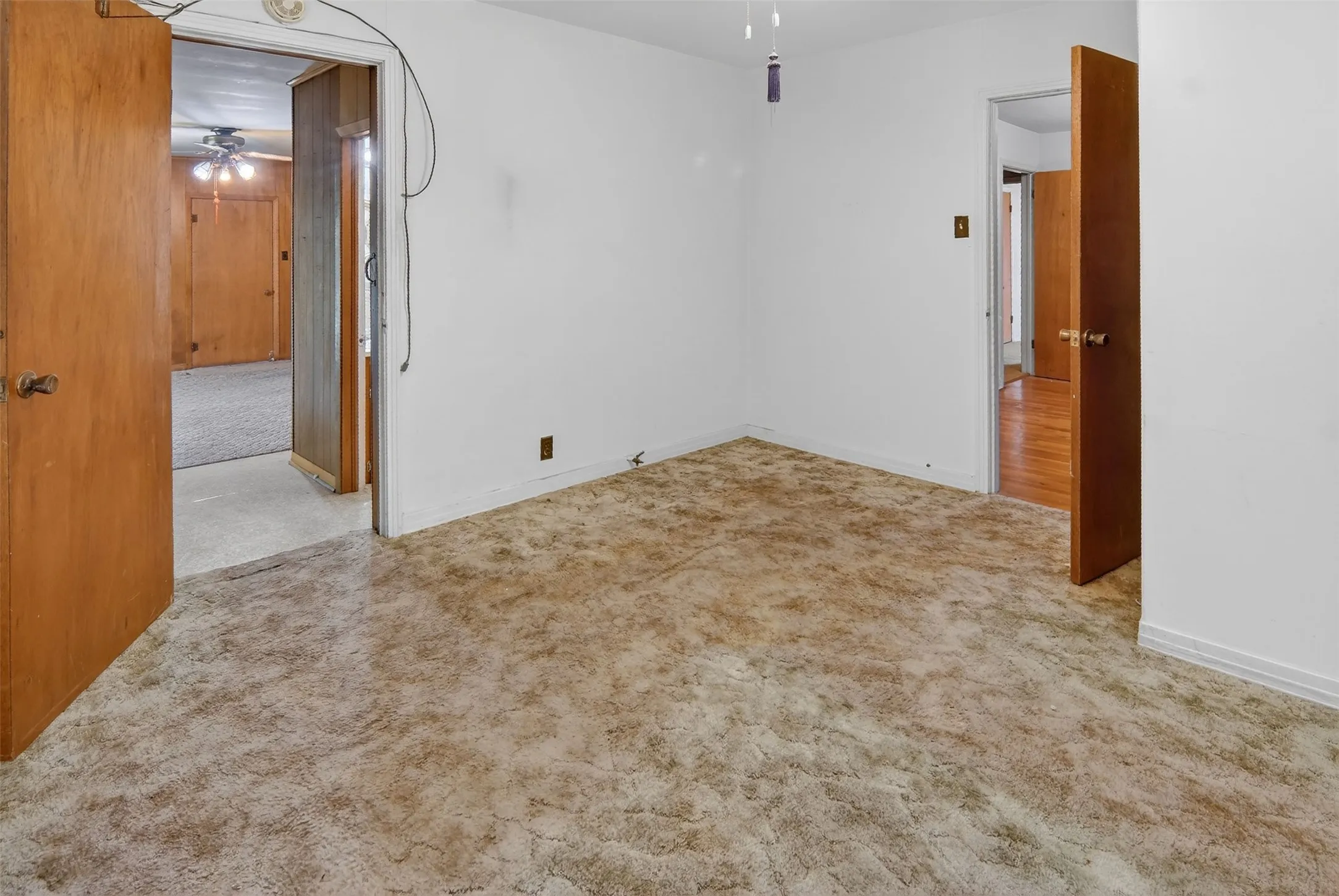Second bedroom features carpet and ceiling fan.