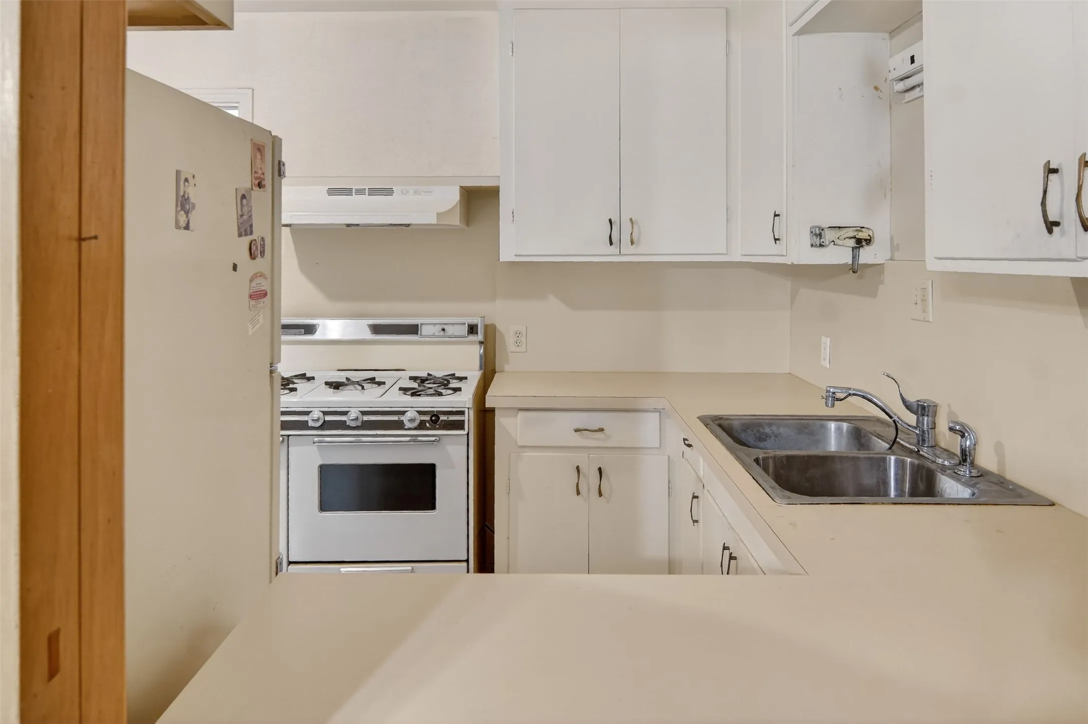 View of kitchen from den through pass-through opening.