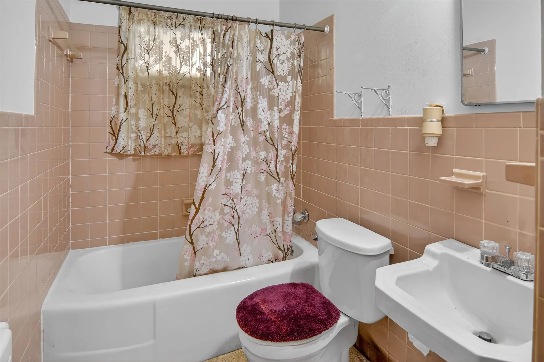 Full bath #1 featuring tile walls and shower / bath combination.
