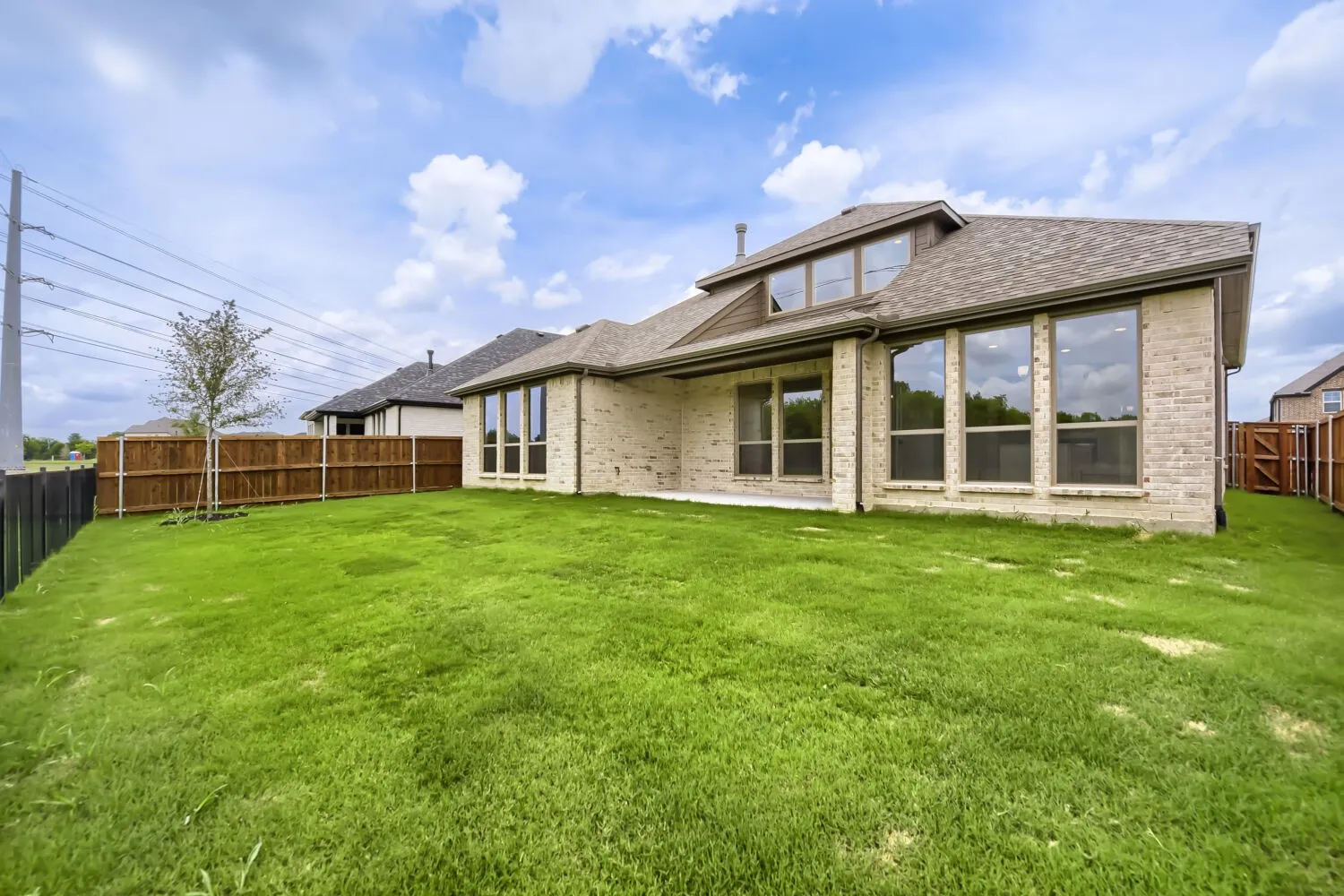 Expansive backyard featuring a large grass lawn