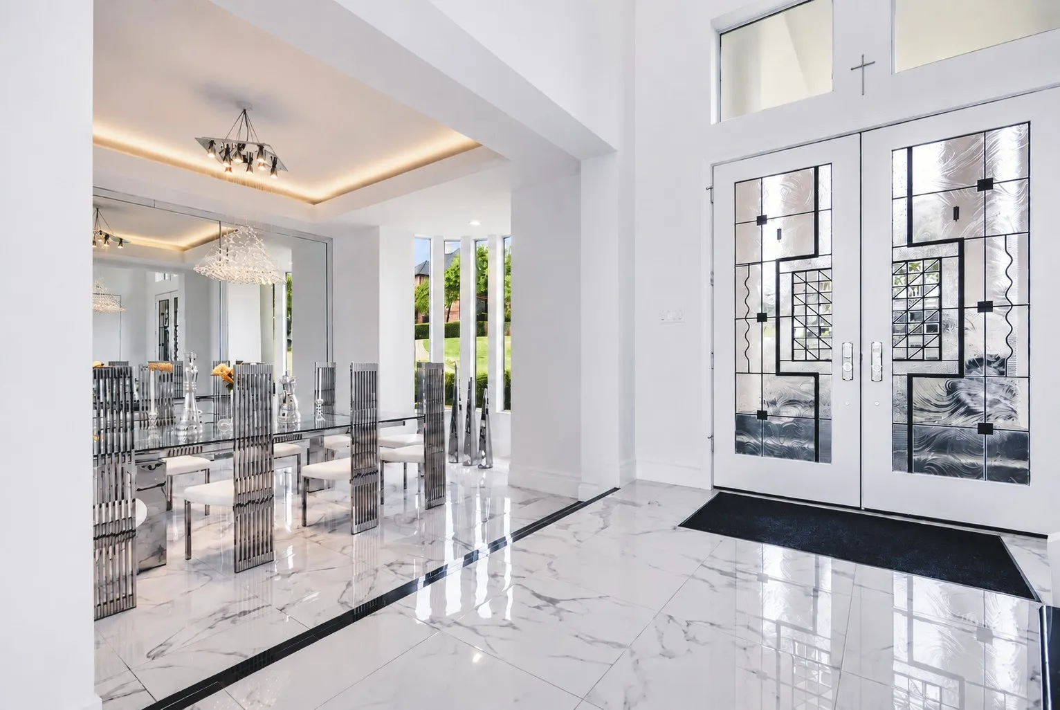 An extraordinary grand foyer welcomes you with soaring ceilings, gleaming floors, and modern designer double doors. Filled with natural light, this elegant space creates a stunning first impression and sets the tone for the home's sophisticated, modern design.