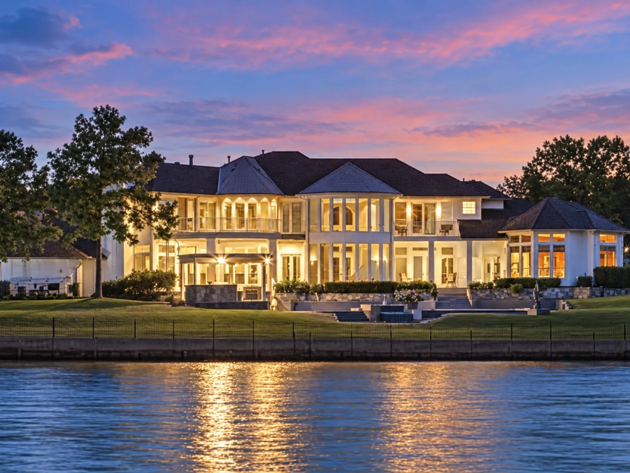 The tranquil lake reflects the home's warm glow, offering the perfect end to each day and the backdrop for creating unforgettable memories with family and friends.