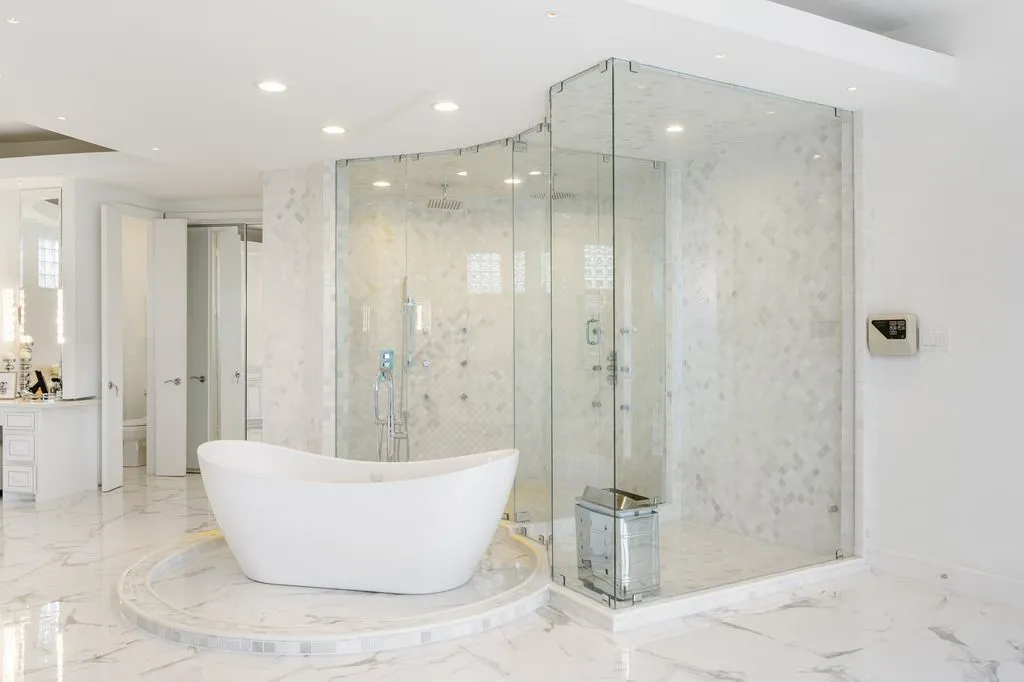 It also features a sleek, glass-enclosed shower equipped with invigorating body jets and a built-in sauna, creating a daily retreat of comfort and relaxation.