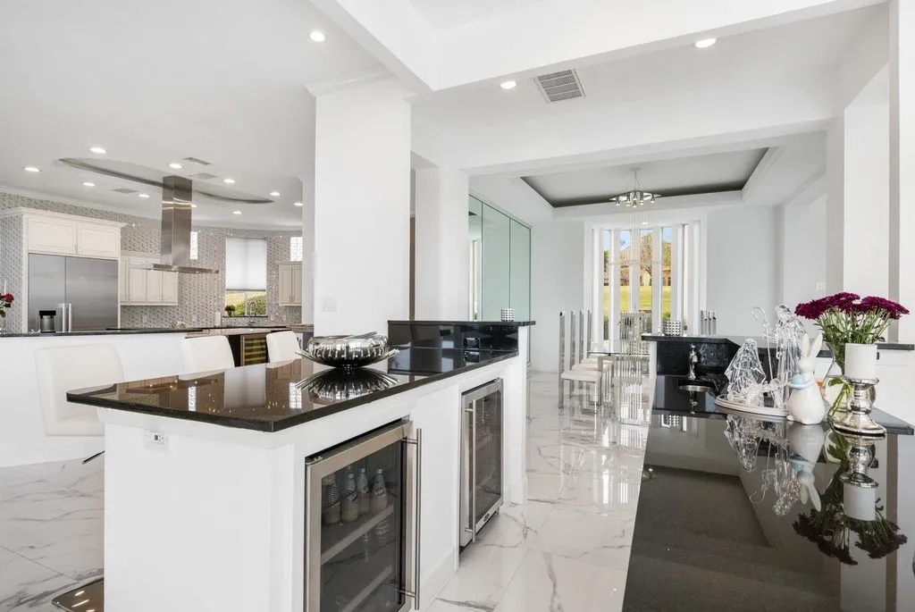 An elegant bar area is complemented by a total of seven wine cellars and beverage centers thoughtfully placed throughout the home.