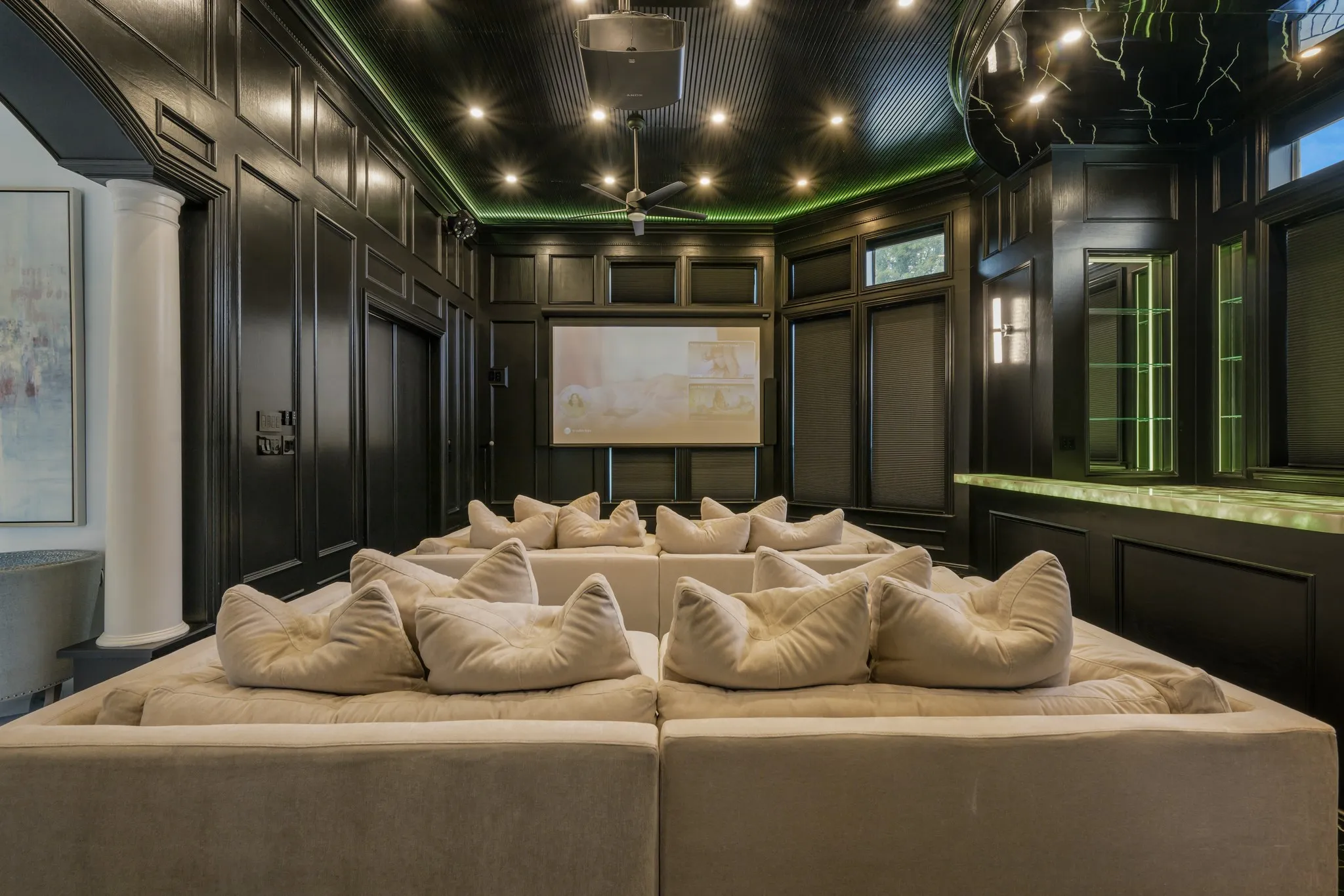 Adding to the experience a custom bar features luxurious, color-changing Cristallo, countertops.