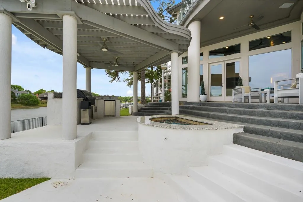 Imagine evenings by the fire pit, grilling in your professional outdoor kitchen, all under a covered deck with serene water views. A private staircase leads directly to your primary suite balcony-seamlessly blending relaxation and luxury.