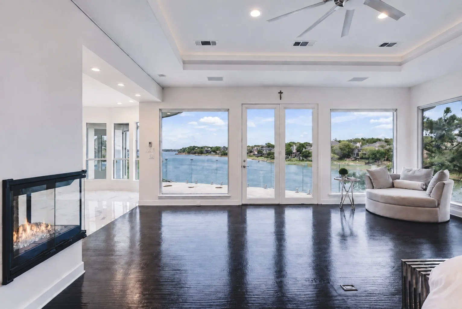 A dramatic wall of windows frames panoramic lake views creating a tranquil, resort-style retreat. With direct access to a private balcony, it's the perfect place to unwind and savor the view at the end of the day.