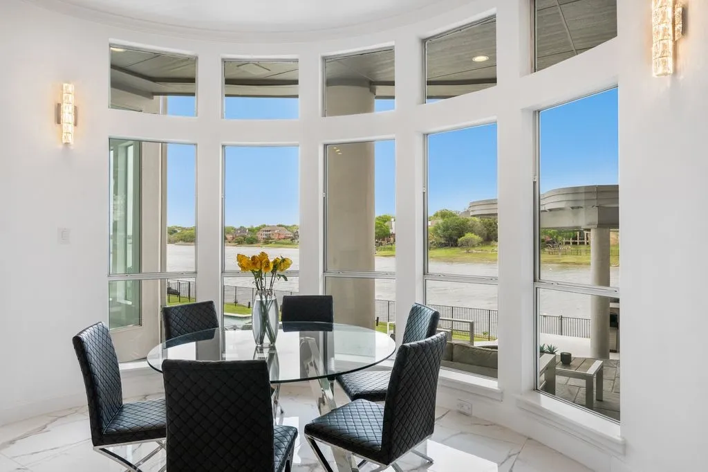 The breakfast area offers a luminous, sun-filled space with captivating lake vistas.