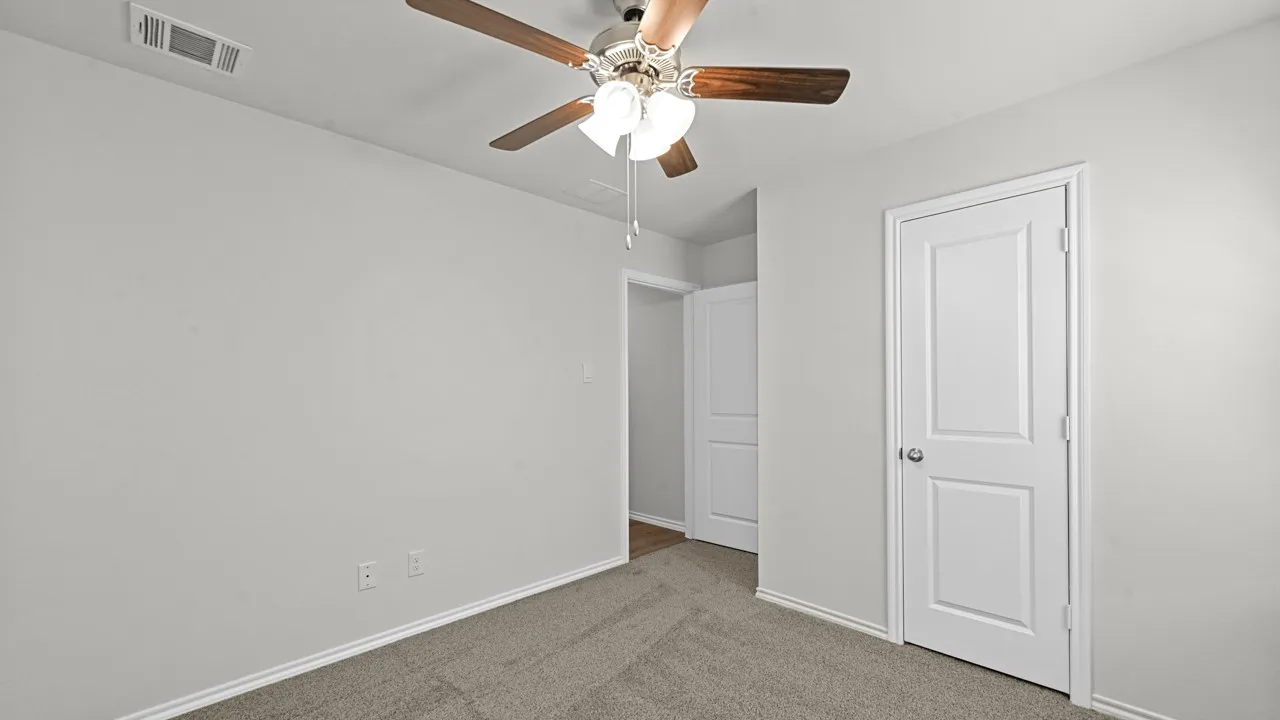 Interior space featuring light gray walls and plush gray carpeting