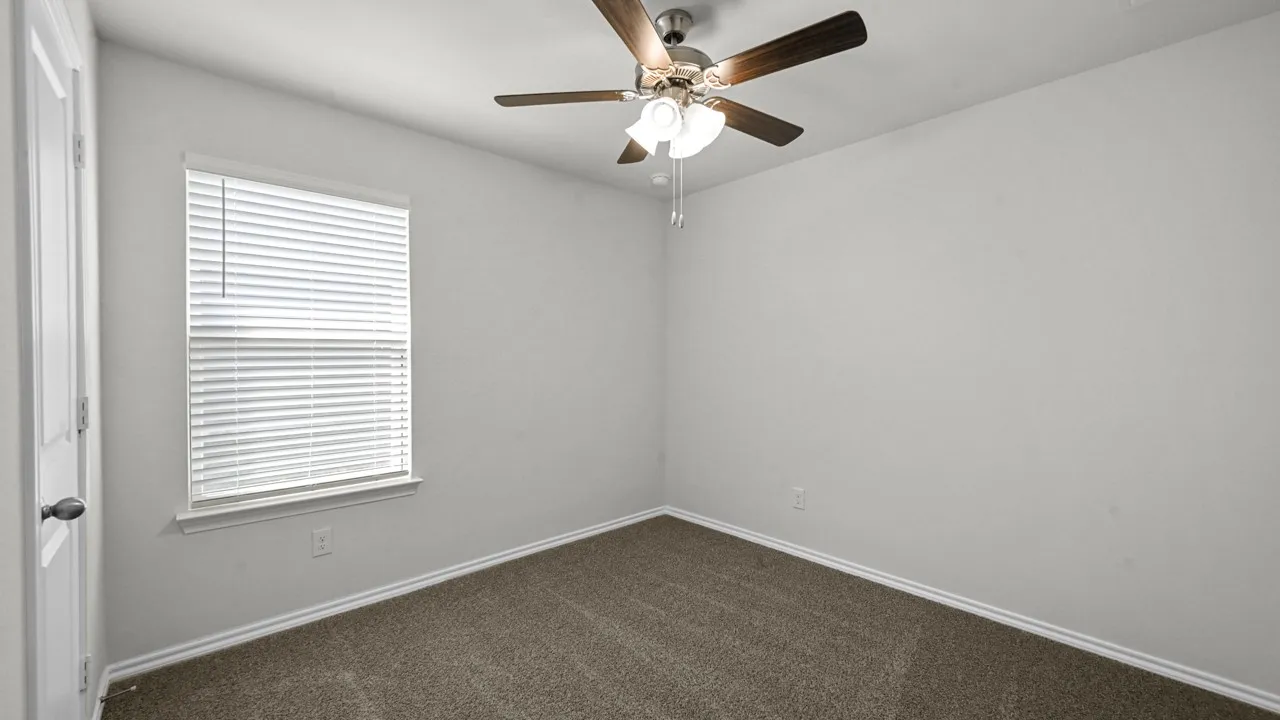Room featuring neutral wall tones, brown carpet flooring, and a ceiling fan with integrated​​‌​​​​‌​​‌‌​‌‌​​​‌‌​‌​‌​‌​​​‌​​ lighting