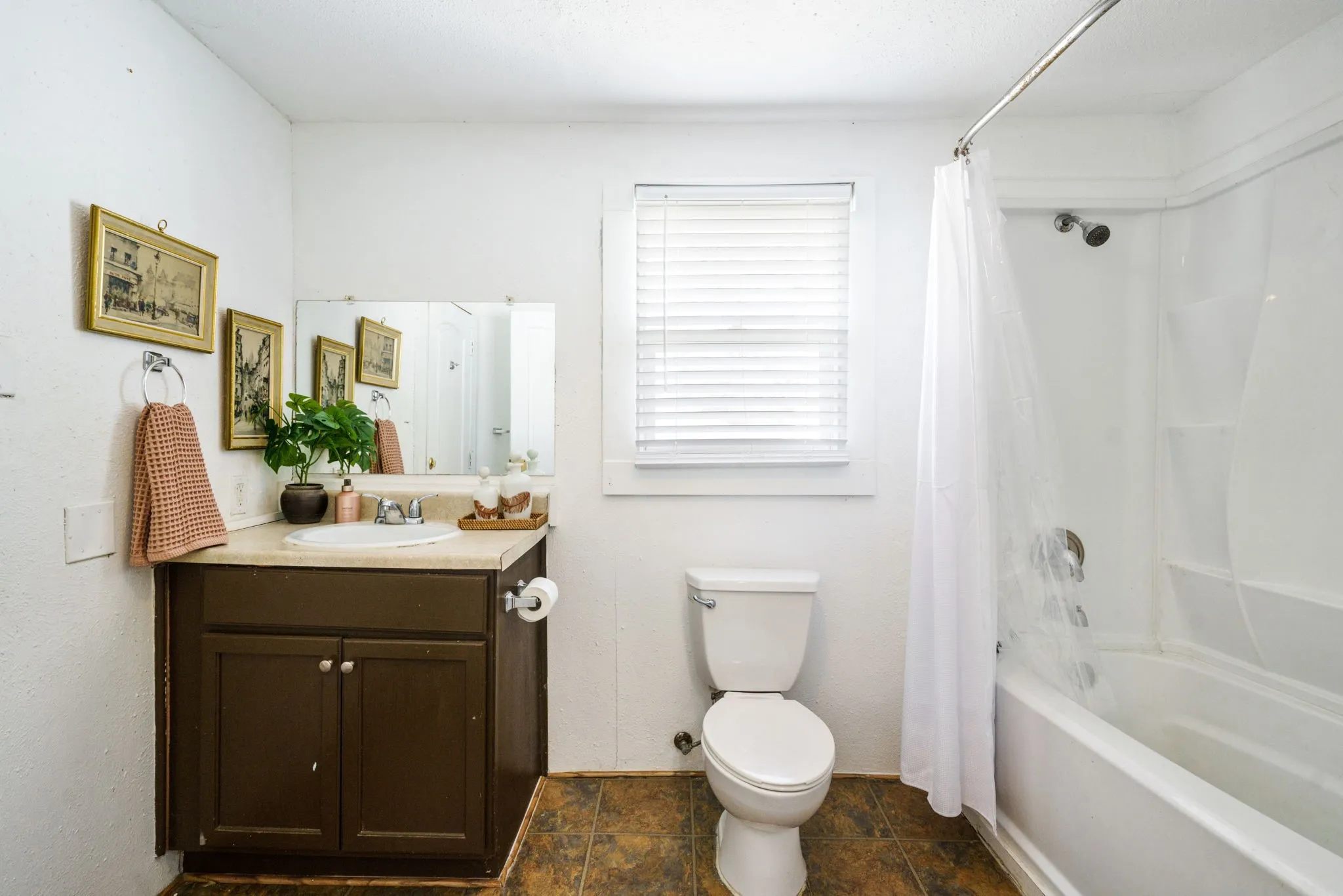 Neatly maintained bathroom with a full tub/shower combination and vanity, providing reliable functionality for tenants or guests.