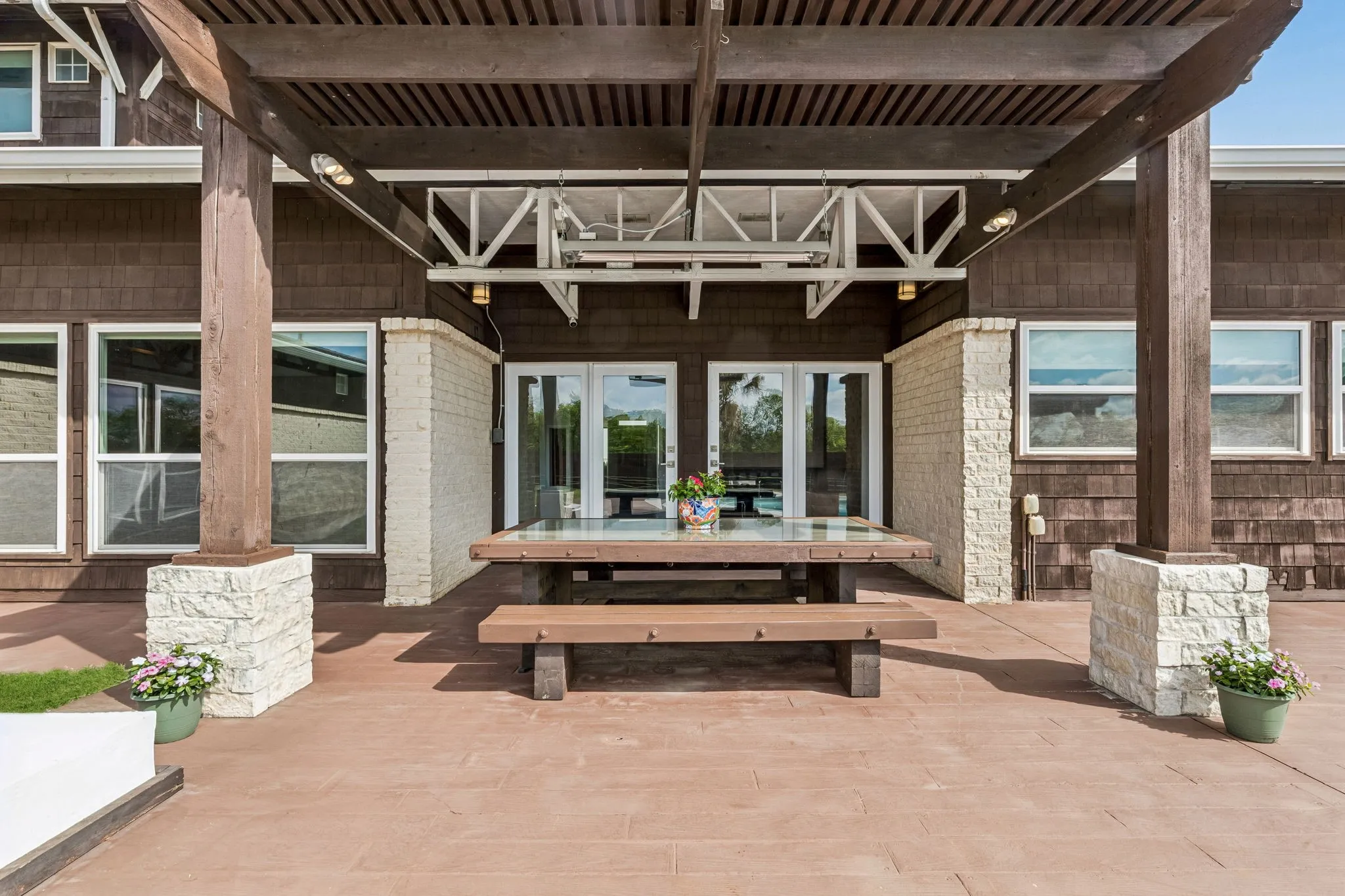 Custom built in heavy wood picnic table with glass inlay top.  Solid covered pergola.