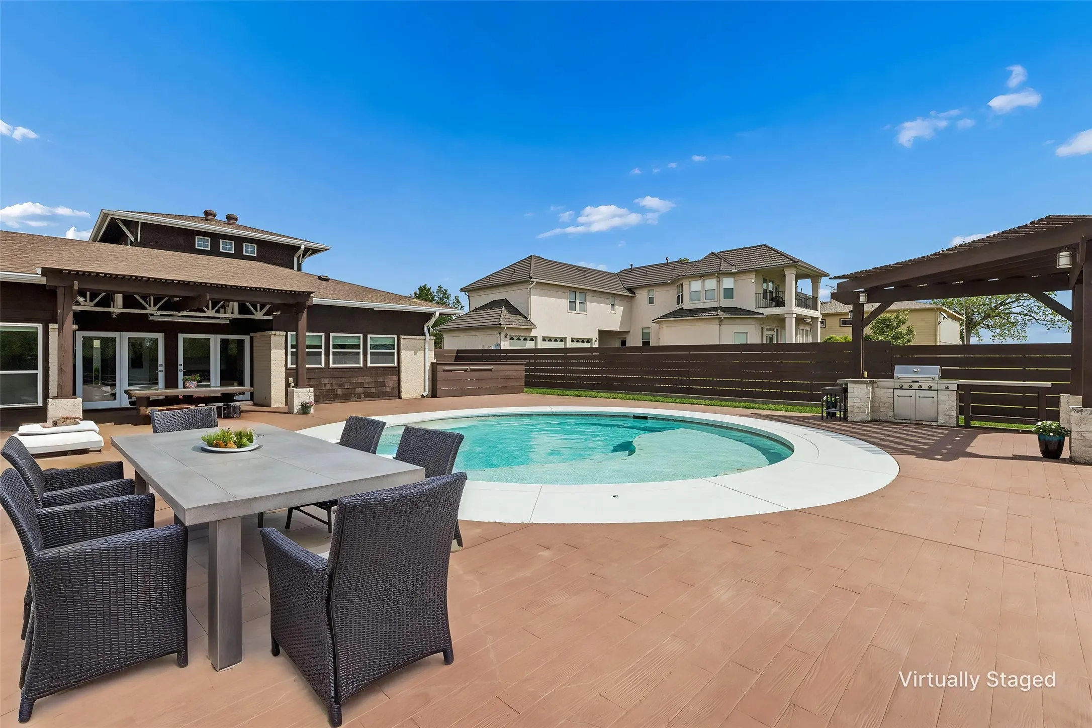 Extensive patio pool area with built in bar, grill and pergola.